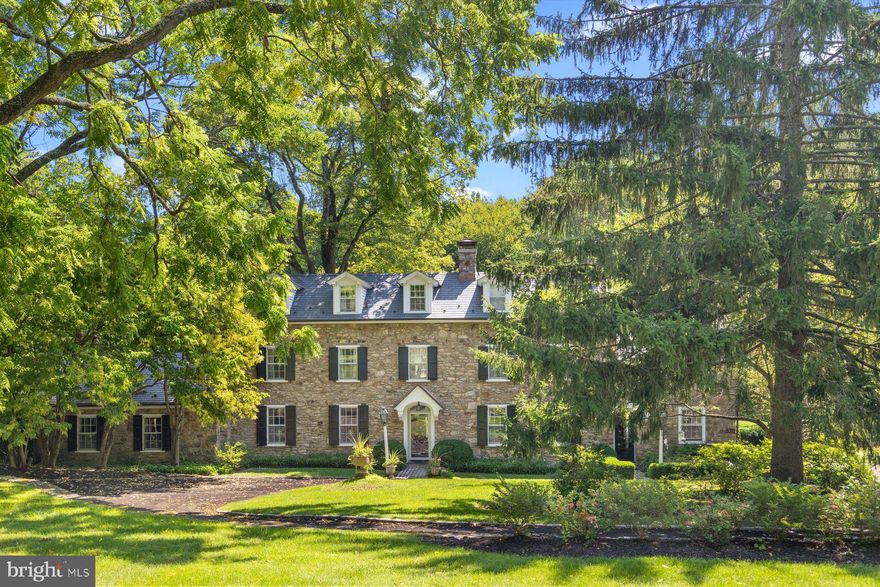 Tucked away in Buckingham Township, Spring Meadow Farm epitomizes the Bucks County farm estate, a tranquil retreat with all of the elements one needs for an upscale country lifestyle. Accessible via two gated entrances, the house is hidden from the road and situated on 18.3 acres, assuring privacy. The pristine setting with 2 stone-walled ponds and creek is a slice of English countryside with a late 18th-century stone manor house at its center. Views from the five-bedroom house are enchanting in every season. A fabulous party barn, comfortable guest house, pool, tennis court, garage, stables and paddocks perfect for horses, goats, sheep or other hobby farm endeavors add to the property’s completeness. The main residence is a gracious retreat with seven fireplaces. While its original sections offer a traditional floorplan with formal living and dining rooms on each side of the center entry hall, later additions are designed to take advantage of the views and indoor-outdoor flow for warm-weather entertaining. The family room is lined in windows and has French doors that open to a large bluestone patio with hillside and stream views. Ever-blooming gardens come to life each spring and provide color all season. A richly paneled library with stone fireplace and hidden bar opens through leaded-glass doors to a garden room with accordion doors that join the indoor and outdoor environments. The light-filled Draper kitchen with island is open to a casual dining area and is well designed for entertaining. Private quarters include five bedrooms and 3.3 baths. The main bedroom suite provides a large sitting room/office/exercise space with private balcony offering exquisite sunrise/sunset views. A walk-in-closet, bedroom with fireplace, and updated bath with radiant heat, soaking tub and other luxe features create comfortable accommodation. A pub/game grotto, on the lower level and plenty of outdoor space provide ample recreation options. There is garage parking for eight cars. The barn is a wealth of open square footage on two floors for almost any hobby or entertainment one wants to pursue. The comfortable, roomy one-bedroom guest house is set away from the main house. Nearby is the two-stall barn that opens to fenced pastures. Schedule a tour of this very serene property, and perhaps you will be the next steward of the refined, private oasis that is Spring Meadow Farm. Seller is a Licensed Realtor.