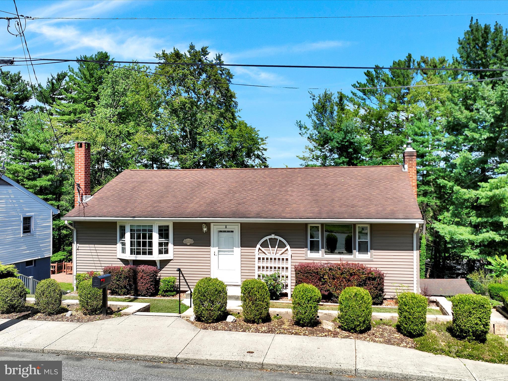 Welcome to this spacious and impressive 4BR/3BA home that perfectly blends comfort with entertainment possibilities. The main floor showcases 3 entry-level bedrooms and 2 bathrooms, featuring a newer, updated kitchen and living room with beautiful bay window that floods the space with natural light. The primary bedroom offers luxury with its large walk-in closet and ensuite bathroom. 2 additional bedrooms and a full bathroom complete this floor. What truly sets this property apart is its incredible recreational potential. The first lower level houses an additional bedroom with fresh carpet, a full bathroom and laundry area. Step down into the second lower level - a bonus room for additional entertaining or office space. The basement/third lower level boasts a full-size bar with eleven-foot ceilings and four bar stools included in the sale – ideal for hosting gatherings or creating your personal retreat. The 2009 addition brings modern functionality to this well-maintained home, complemented by bright, neutral paint colors throughout. Three heating zones and dual circuit breakers ensure year-round comfort and efficiency, while the insulated crawl space adds practical value. Step outside to discover the large, flat backyard featuring mature landscaping, hardscaping, a storage shed, and pavilion. The expansive deck offers gorgeous sunset views – perfect for evening relaxation. Beautiful driftwood siding enhances the home's curb appeal. Location advantages include close proximity to Pottsville Area High School, public courts, and the popular Pottsville walking trail. This beautiful neighborhood offers convenience without sacrificing tranquility. With 4 air conditioning units included, multiple recreational spaces, and thoughtful updates throughout, this home delivers both immediate comfort and endless possibilities for personalization. The combination of indoor entertainment areas and exceptional outdoor space creates the perfect environment for both daily living and special occasions. Move-in ready home that has been meticulously maintained; schedule your private tour and enjoy. Pride of ownership is evident. Offers welcome!