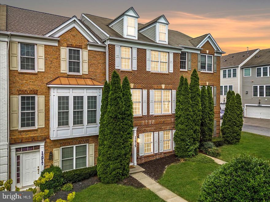 Buyers loss your gain - super clean home inspection! Just minutes from Black Hills Regional Park, Clarksburg Outlets, I-270, and Milestone, this stately brick front townhome in Summerfield Crossing is ready for you!  Move in ready freshly painted and cleaned, gleaming hardwood floors throughout and a clever layout, there's nothing to do but unpack!  New A/C in 2023, so the summer heat has no chance. Bring your eco friendly vehicle; owner added a fully permitted electric car charger in the garage. Entry level provides an office/den with French doors with elevated crown moulding, perfect for work or play!  Garage entry from the back and ample storage underneath the stairs and inside garage. Don't like yard work? Then this may catch your fancy!
The second level brings lots of wonderful natural light through the front and back of the house!  Kitchen feels gourmet with 42' wood cabinetry, granite countertops, tile backsplash and gas range. Stainless steel appliances about 5 years young (dishwasher was new in Feb 2024).  Cozy up in the living room with the two sided gas fireplace or enjoy coffee in the breakfast nook.  A true dining room for more special occasions is also elevated with double crown moulding and wainscoting. 
The top level houses your laundry (washer and dryer just 5 years old), what a convenience right outside the bedrooms!  A true primary suite feels luxurious with a walk-in closet, private bath, tray ceiling and large windows.  Primary bath includes water closet, walk in shower, soaking tub and double sinks for a modern lifestyle.  Two other generously sized bedrooms, all with hardwood floors, and full bath round out the home.  Playground right across the street and facing common green area, there is no outdoor maintenance but you have the ease of enjoying the outdoors!  Close to major commuter routes and shopping and just an hour outside DC and Baltimore! HOA does not allow decks on townhomes in the neighborhood.