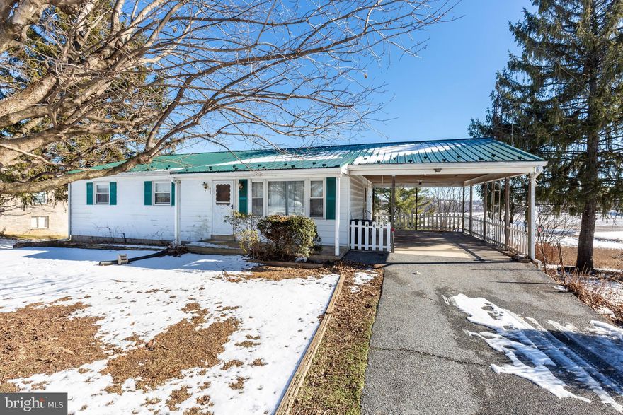 One owner rancher just outside of Union Bridge awaits the next owner.  So much potential to spruce up this spacious 3 bedroom rancher overlooking farmland.  Metal roof, front porch, carport, shed, full basement with rec room, wood stove, sunroom , lots of storage and walk out.  The home is dated inside, but appears to have good bones, lots of kitchen cabinets, spacious living room, nice size closets,  separate dining area and walk up attic area.  Wood floors throughout main level are in poor condition at this time.  Bath has a walk in shower and double vanity. On site septic with a well for hose bib, toilets.  Water source is public/County.   Take a look, bring your decorating ideas and make an offer.