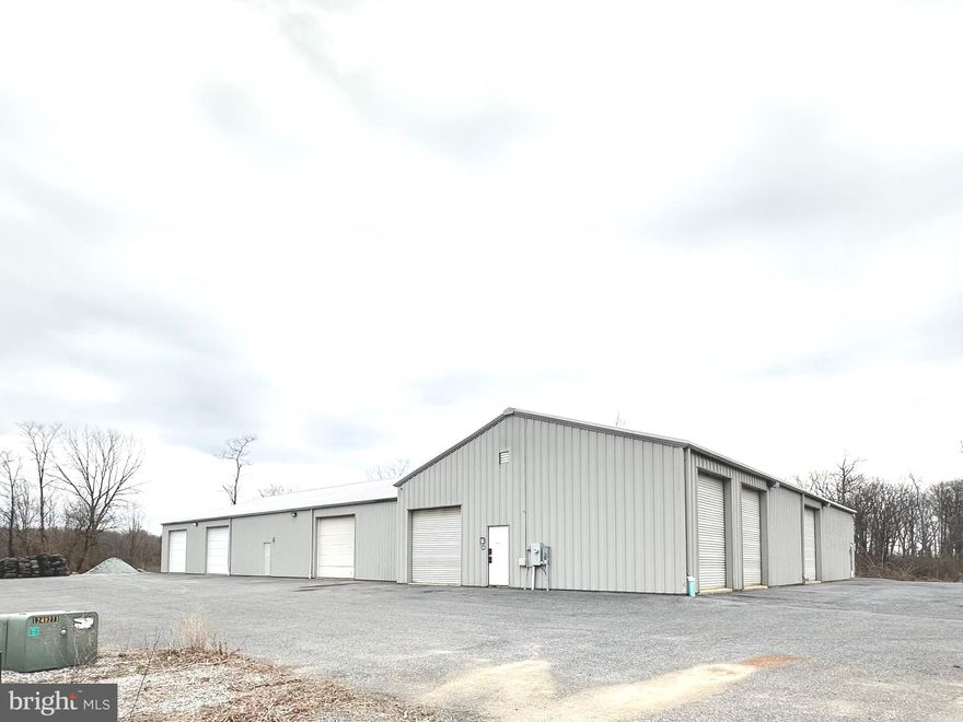6317 Rock Hill Rd in Chambersburg, PA, is a versatile commercial property located conveniently between Chambersburg and Waynesboro. It features two steel buildings, built in 2012 with a total area of approximately 9800 square feet (Front building 40 x 95, back building 60 x 100) designed for light industrial or commercial use. Highlights include ample workspace, office space, built-in cabinetry, 400-amp electrical service, 2 - 12 x 10, 1 - 12 x 12,  1- 10 x 10, 3 - 11 x 12 (7 total garage doors), plenty of room for your business needs. Both buildings are air conditioned, heated (radiant flooring, outdoor wood burner), and the front building has 1 customer 1/2 bathroom and 1 employee full bathroom .  There are also 2 RV spots to the left hand side of the back building that have water (cistern), septic and electric available. The property sits on over two acres, providing generous parking and accessibility, ideal for manufacturing, service businesses, or storage needs.