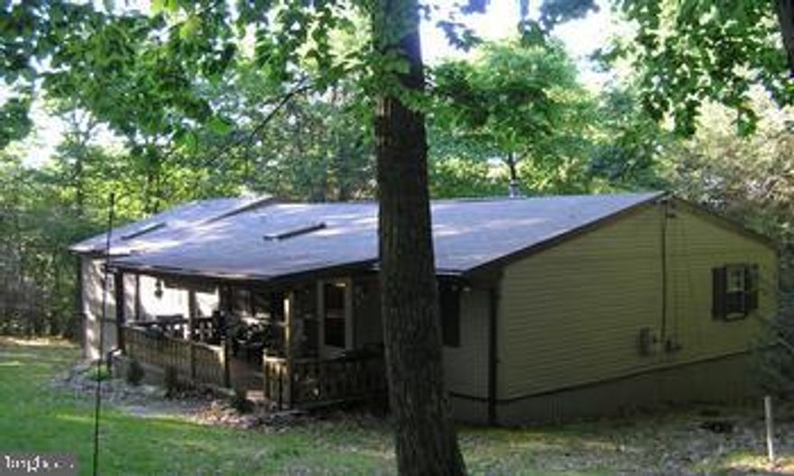 It is an understatement to call this a cabin, because it has all the modern conveniences of a home. It has a woodstove, built-in grill on deck, large master suite with 3/4 bath, gas fireplace, sitting area, and private deck. On top of all that it comes COMPLETELY FURNISHED, thats right everything with the exception of some small personal items stays with this home. This is only the beginning so CALL TODAY for all the details!