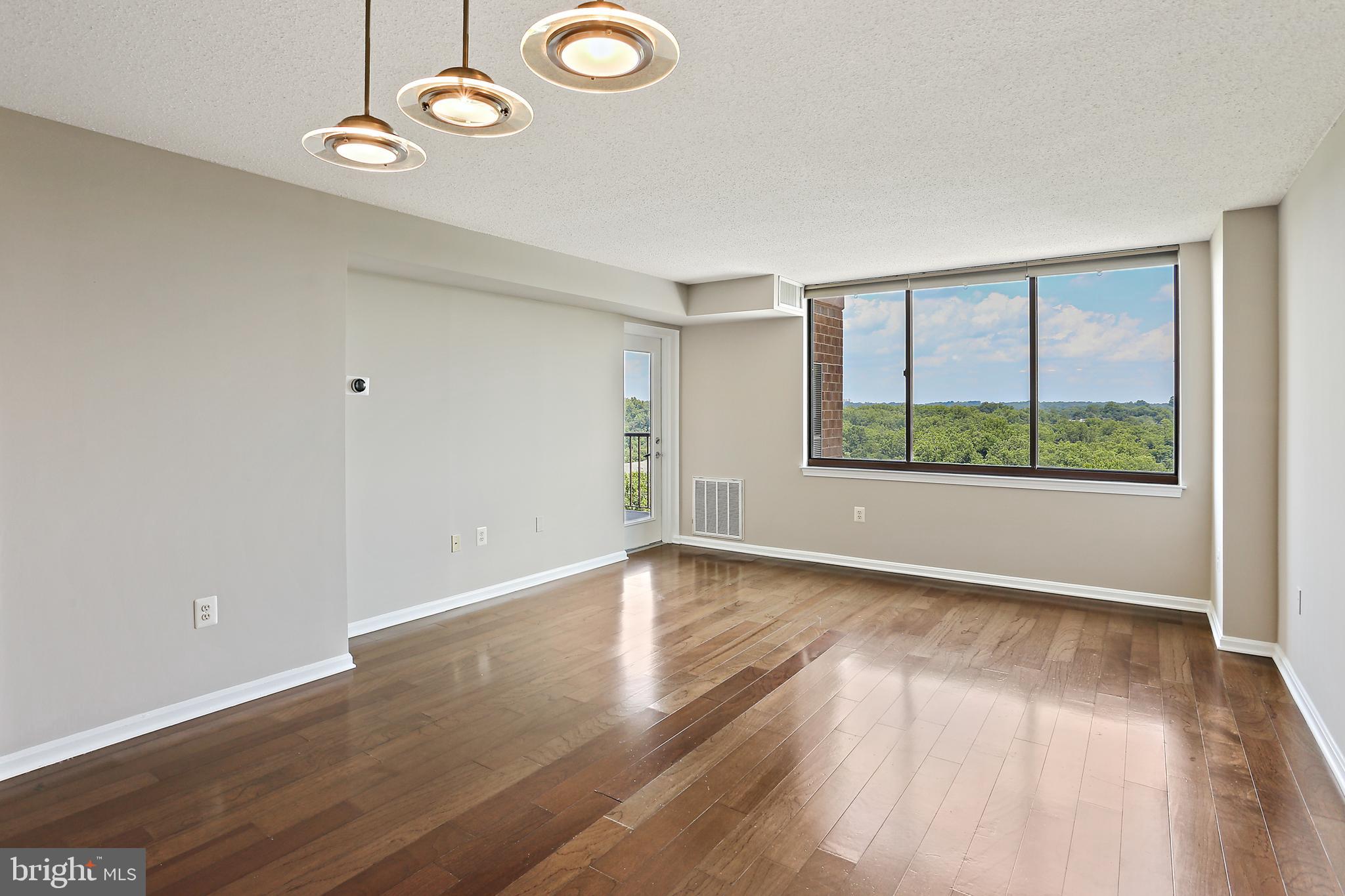 Come visit this updated, spacious 2 BR condo in desirable 10101 Grosvenor Park. Freshly painted throughout. Updated kitchen with wood floors in kitchen and family room. Two large carpeted bedrooms. Oversized private balcony off the family room with picturesque and awesome views. Entry to balcony from master bedroom as well. RARE TWO ASSIGNED PARKING SPACES, one inside parking garage with direct access to walkway to residential building. Second parking space in exterior parking lot. Exceptional building amenities, including 24/7 concierge services, gym, outdoor pool, sauna, lounge, media room, business center, and tennis courts for an elevated living experience. Walking Distance to Grosvenor/Strathmore Redline Metro. Only one Stop Sign away from 355, 495 & 270. Close to NIH, Naval Hospital, Rock Creek Park and all North Bethesda has to offer!