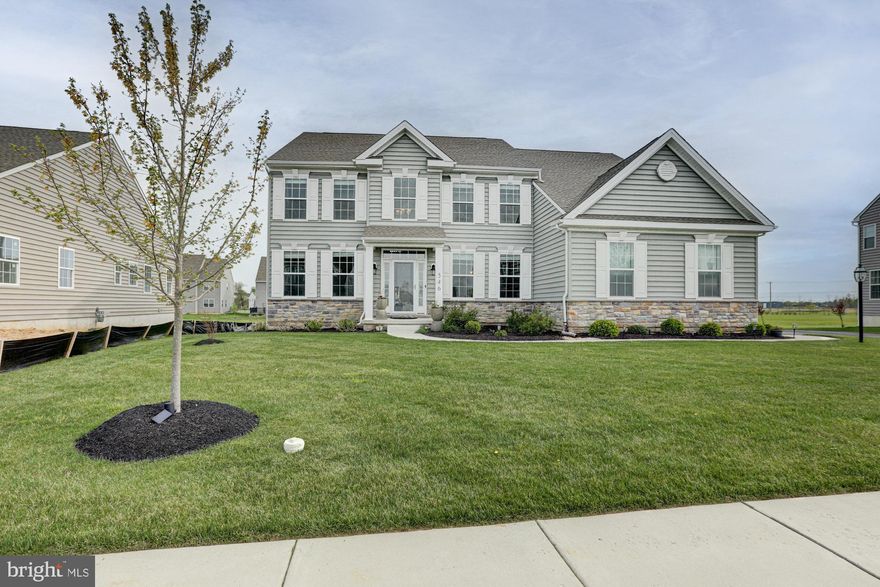 Welcome to 546 Buck Tavern Drive, a like-new, impeccably upgraded luxury residence in the prestigious community of Rothwell Estates in Middletown.

Built in 2022 and set on a beautifully landscaped 0.28-acre homesite, this exceptional property offers over 3,300 square feet of thoughtfully designed living space where sophistication meets everyday comfort.

From the moment you arrive, you’re welcomed by a grand two-story foyer with soaring ceilings and sightlines that lead effortlessly into the breathtaking main living area. Here, dramatic cathedral ceilings, expansive windows, and a striking fireplace create a light-filled statement space that feels both elevated and inviting.

Designed with both entertaining and daily living in mind, the home features elegant formal living and dining rooms, complemented by a stunning gourmet kitchen outfitted with quartz countertops, stainless steel appliances, abundant cabinetry, and a spacious eat-in area perfect for gathering.

The main level offers exceptional versatility, featuring a private bedroom with a beautifully appointed en suite bath, ideal for guests or multi-generational living. A well-designed mudroom enhances everyday convenience with a dedicated washer and dryer, blending functionality seamlessly into the home’s elevated design. The entire home has been freshly painted, offering a crisp, move-in-ready feel.

Upstairs, a dramatic catwalk overlooks the main living space, adding architectural interest and an open, airy ambiance. Four generously sized bedrooms complete the upper level, including a luxurious primary suite featuring a spa-inspired bath with a soaking tub, creating the perfect retreat at the end of the day. There is also a full laundry room on the second floor for added convenience. 

The expansive lower level offers incredible flexibility, with a partially finished area ideal for additional living or recreation space, along with a large unfinished section ready for storage or future customization.

The home is thoughtfully equipped for modern, energy-efficient living, featuring a newly installed 20-panel solar system designed to reduce utility costs and environmental impact. An electric vehicle charging station in the garage adds everyday convenience, making this home as functional as it is forward-thinking.

With five bedrooms, three full bathrooms, one half bath, upgrades and access to the highly sought-after Appoquinimink School District, this home delivers an exceptional combination of style, space, and location.

This is more than a home, it’s a statement of modern luxury living. Schedule your private tour today.