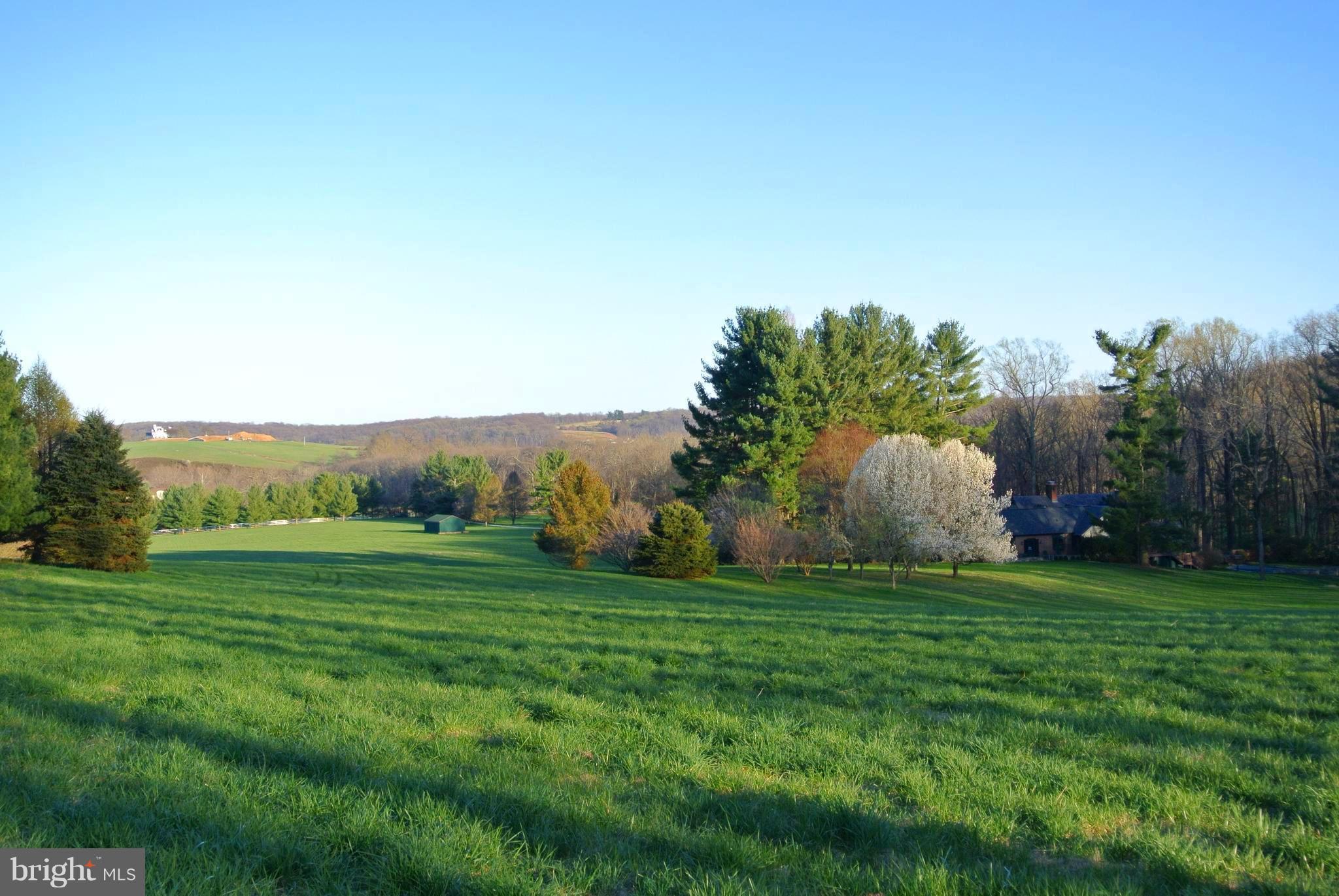 A rare offering in the center of the renowned Maryland Hunt Country a coveted valley location known for sporting traditions & land preservation. 25 rolling acres with remarkable panoramic vistas plus separate 8 ac parcel with stream. 3BR+/4.5BA cape, guesthouse, 3-stall barn, pastureland, woodland forest, 3 small spring-fed iris ponds, saltwater pool, reflecting pool, walking & riding paths.