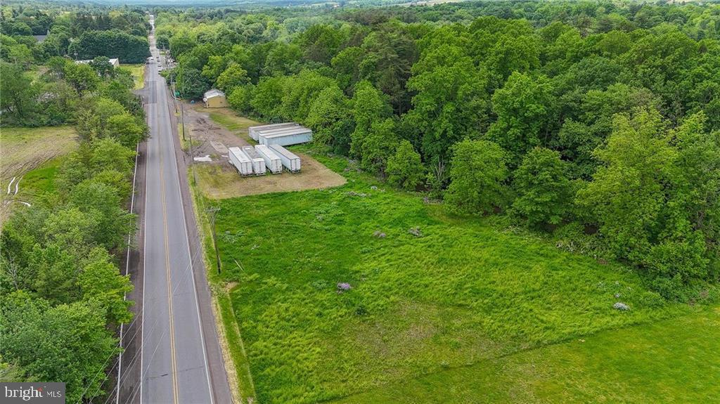Tremendous opportunity to own over 12 acres of combined Commercial and Residential land in a rapidly expanding area. The Planned Commercial portion borders PA-443 with 660 feet of road frontage and, situated between Lehighton and Tamaqua, offers tremendous exposure to passing traffic! The commercial portion of this property totals 1.87 ACRES (81,721 sq ft) and 1.12 ACRES (49,209 sq ft) of that commercial frontage on PA-443 has been removed from the flood zone making development that much easier! An 1800+sf Steel Structure warehouse features one garage bay. However, there is room for a potential of three bays and dedicated office space – ideal launching pad for your business! A stream separates the commercial acreage from the wooded, residential zoned (R1) acreage. Ample land to suit a multitude of purposes! The location also cannot be matched with the rapid commercial and health network expansion in this direct area and its proximity to the PA Turnpike NE Extension, Jim Thorpe, the Poconos, and the Greater Lehigh Valley! Don’t miss this unique and marvelous opportunity!