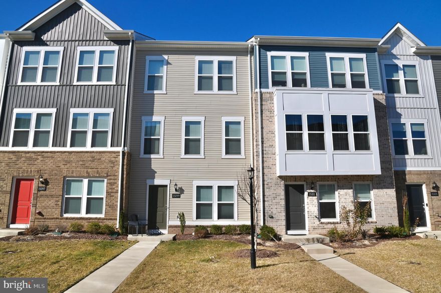 Welcome to Highly Desired Crossroads Village Center in the heart of Haymarket! This three-level townhome offers nearly 2,000 sq ft of stylish living. Built in 2023, this home combines sleek design with everyday functionality. The entry level offers a versatile flex space- perfect for a home office, gym, or media room, complete with a rough-in for a full bathroom plus a 2 car garage. The main level is a true showpiece, featuring an open-concept kitchen with quartz countertops, a large island with seating for five, stainless steel appliances, and seamless flow to the dining area and living room. Step onto the private back deck, ideal for morning coffee or evening gatherings. Upstairs, the spacious primary suite includes a modern en-suite bathroom, complemented by two additional bedrooms and a full hall bath. Flooded with natural light and finished with contemporary details throughout, this home offers both comfort and sophistication. Enjoy being just seconds to local favorites like Tony’s New York Pizza, Hidden Julles Café, Red House Tavern, Fosters, Bruster's Ice Cream, Crumbl Cookies, Giuseppe's, El VaQuero West, Parrando’s Tex-Mex Grill and many more! Outdoor recreation abounds at Silver Lake Regional Park and James S. Long Regional Park, while the shops and charm of Historic Haymarket are just minutes away. With easy access to I-66, Route 15, and Route 55, commuting to D.C. and beyond is effortless.