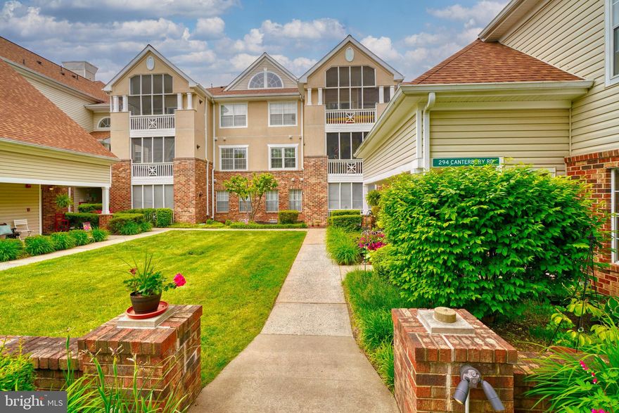 Welcome to 294-M Canterbury Road in sought after English Country Manor with rarely available ONE CAR GARAGE!  This recently updated top floor condo features two generously sized bedrooms with an ensuite in the primary bedroom. Updated kitchen with quartz countertops, gray cabinets and upgraded appliances. Living room has vaulted ceilings with wood burning fireplace and access to the screened-in porch! New luxury vinyl plank flooring & fresh paint throughout,  along with updated light fixtures. Detached  ONE CAR GARAGE (#8) is included, along with 2 extra parking spots. Community center with in-ground pool, exercise room, party room & more! Easily access the Ma & Pa Trails right behind the building. Water is included in monthly condo fees. Professional photos coming!