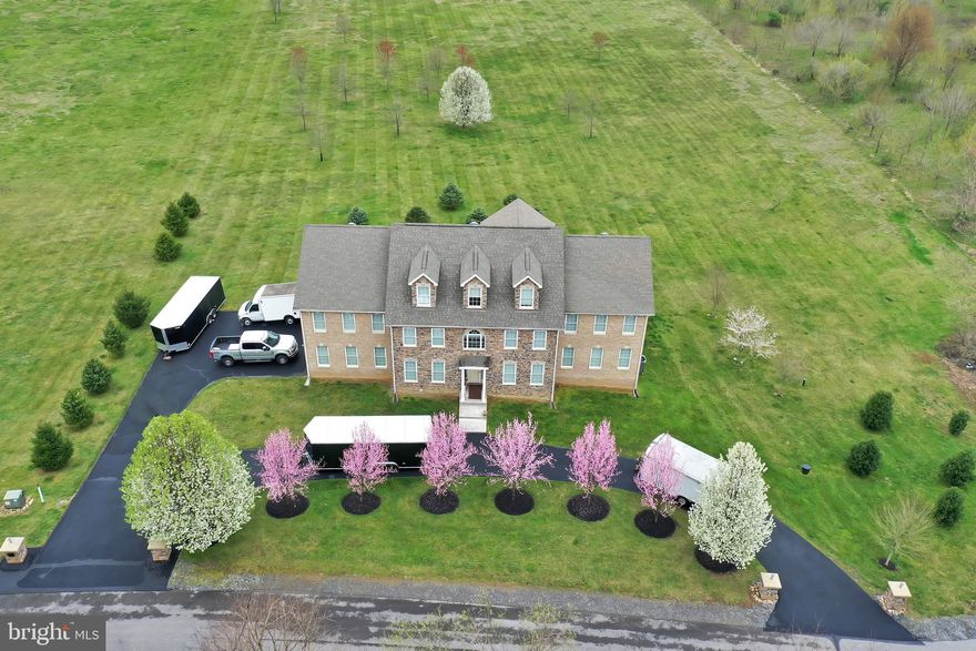 THIS IS ONE OF A KIND    This Georgian Manor style home is great for the large family,  Mother-in-law suite, so the family can be together.  This home has been well taken care of with every detail sure to please.  This home sits in a gated Potomac River Community in a rural area of Hedgesville.  This exceptional 4 story home has stone and brick throughout, which sits on 4.28 AC.  This home features  9 Bedrooms, and 7.5 baths on the upper floors, with 2 bedrooms, and 2 baths finished on the lower level.  This exquisite home has 3 Master Suites, 1 on the main level, and 2 on the 2nd floor.  Master baths  with Jacuzzi tubs, walk in shower, double sink vanity, walk-in closet with shelving.  1 of the upper Master Suites has a fireplace in it and a sitting room to enjoy the fireplace.  Living Room has a unique ceiling with fireplace to warm during cold nights.  The Den has panels in it that would be perfect for a office or great for a show piece.  Private dining room, laundry room on the 1st floor with upgraded washer and dryer.  Wet Bar off of the kitchen, separate kitchen nook, and a staircase carpeted with  oriental.  Silestone counter tops in the main Kitchen, with all the updated appliances.  Plenty of cabinets for the larger family.  The island has cabinets underneath for more storage.  The lower Kitchen has all the appliances for also a small family or Mother-in-law.   Lower laundry room also.  The lower level has a theatre area, and much more.  Circular driveway which leads to a 3 car garage.   This home sits on a cul-de-sac and has privacy.  This home has access to the Community Marina and Potomac River.  6 miles to I-81 and 14 miles to I-70, and Marc Train is nearby in Martinsburg. This home is a showcase for the right buyer.  Flowering trees line the front of the home in the spring which is spectular.