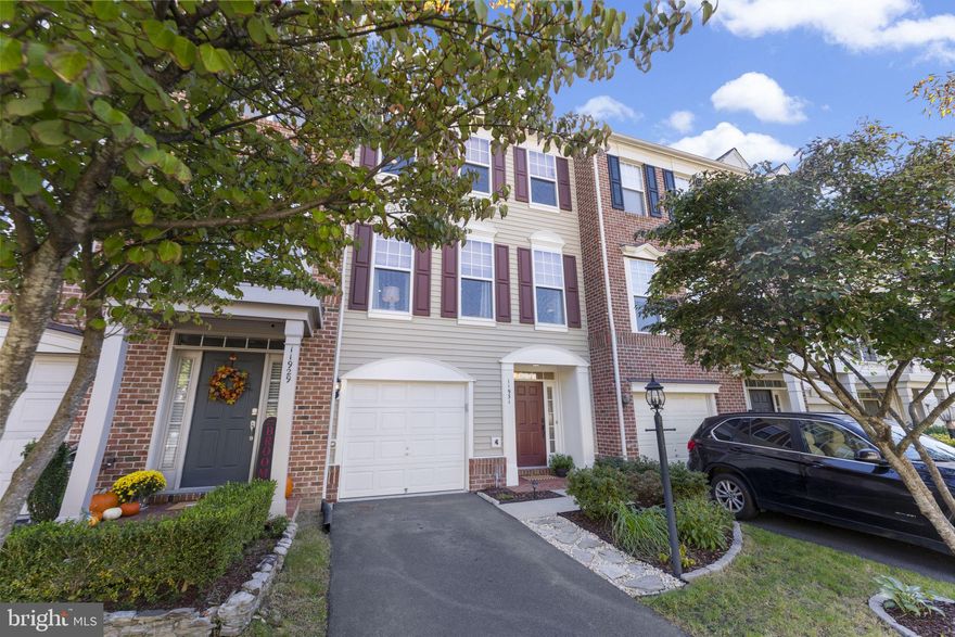 This exquisite three-level townhouse in the Community of Victory Lakes in Bristow is move-in ready, offering over 2,300 square feet adorned with modern touches and upgrades. The property features a newly replaced architectural shingle roof, a contemporary deck, and a fenced-in backyard ideal for entertaining guests. 
The open and spacious floor plan includes a chef's kitchen equipped with granite countertops, upgraded stainless steel appliances, and high-end cherry cabinets with extended custom cabinetry and wine rack/glass holders that create a striking feature wall in the dining area. The main living level is enhanced by hardwood floors, freshly painted neutral walls, 9-foot ceilings leading to the expansive deck.
On the upper level, the primary suite boasts vaulted ceilings, a separate soaking tub, and a glass-enclosed shower.  A laundry room located on the upper level adds to the home's practicality without sacrificing luxury. The lower level offers versatile space suitable for a family room, home office, or guest suite, with a cozy fireplace and half bath for all the comforts of home. The sliding door to the backyard offers plenty of natural light to the lower level. 
 The additional bedrooms are spacious and filled with natural light, making this home ideal for families. The exterior features meticulously maintained landscaping and a freshly painted welcoming entrance. The owners have demonstrated exceptional care for the property, with a new HVAC system installed in 2021 and a water heater replaced in 2018. Additionally, the air ducts and dryer vents have been professionally cleaned and fresh paint throughout all three levels - this is truly move in ready!
 The community's well-maintained common areas and proximity to local schools and shopping centers further enhance the appeal of this beautiful townhouse situated in a desirable community that offers amenities such as a swimming pool, clubhouse, walking trails, and playgrounds, this townhouse perfectly blends luxury and convenience for modern living.