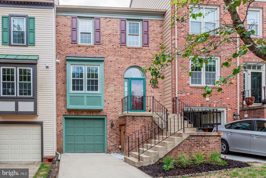 Brick three level garage townhome backing to woods.  You cant beat this location just off the parkway near metro stop, metro rail , trails and parks.  One car garage with two more spaces in the extra wide driveway.  Loads of natural light & vaulted ceilings in this open floorplan home. Remodeled kitchen with granite,undercounter lighting, undermount sink and tile floor.  Step down living room with marble surround fireplace & access to deck. Dining room with new brush nickle chandelier and room for a hutch. Master suite with cathedral ceilings and his and her closet with organizers .  Luxury master bath with separate tub and shower, tile surround and his and her sinks. Full walk out basement with double windows and SGD, brick fireplace, separate finished laundry room & half bath.  The front yard is mowed by the association.  The back yard is so little maintenance with a concrete covered patio and brick patio facing the trees. Dont miss the great storage area under the front stoop its larger than it looks.