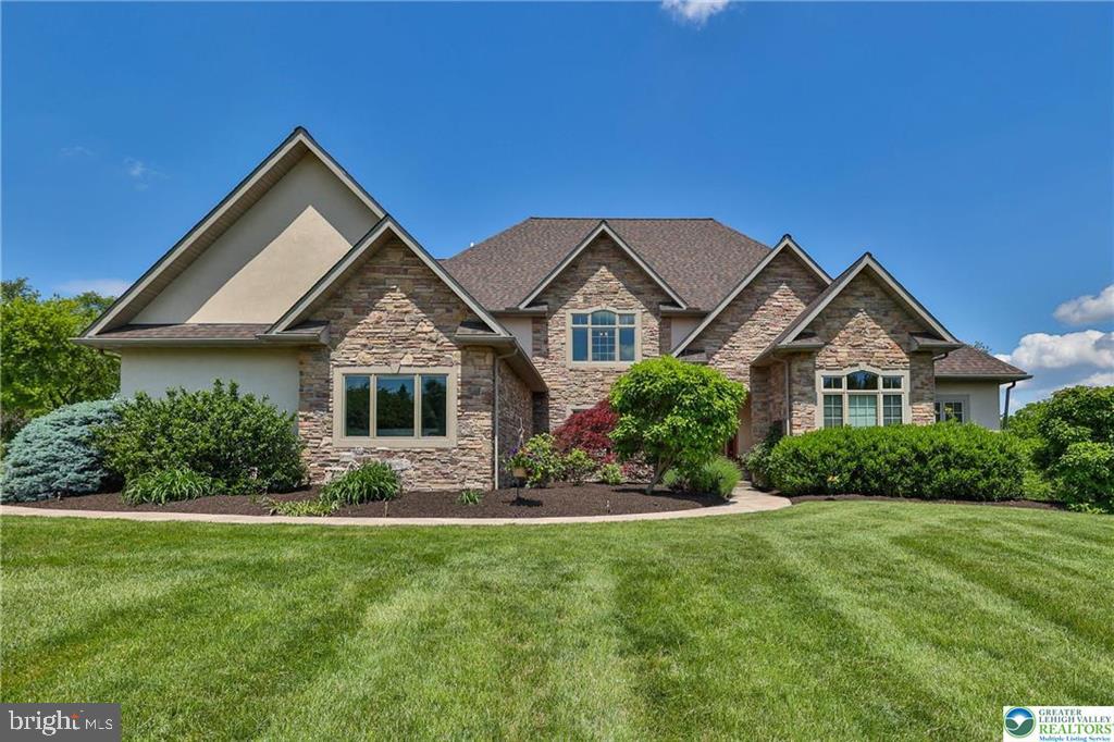 Discover this once in a lifetime custom home designed and built to perfection by the present owner. Sited in the exclusive and appropriately named Far View Farms, this spectacular property beckons. Walk through the door...there's space galore, with tall ceilings, bright windows, a huge kitchen for chefs with endless stone counters that gleam and a dining room ready for your fanciest dreams. There's room for everyone, with a total of 5 bedrooms, including a serene main floor primary, 3 spacious upper floor bedrooms, and what was conceived as extended living quarters in the lower level which includes a rough in for a second kitchen. Complete the picture with 6 walk in closets, a restaurant sized pantry, huge 4 car heated garage and you're almost home. A meticulously maintained flat lot of well over an acre, complemented by extensive hardscape and an abundance of specimen plantings offers a perfect setting to realize your outdoor desires. Easy access to hospitals, major highways and all points make this home a must see. Call for your private showing today.