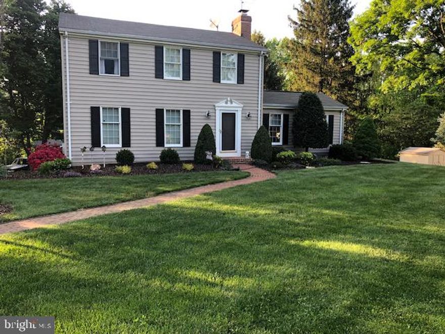 Such a special home - this beautifully kept colonial has updated kitchen, family room off kitchen with wood burning fireplace and custom built-ins, new vinylplank style  floors, updated baths and a great "flow".  Ceiling fans in kitchen, family room, and all three bedrooms. Lower level walkout with rear garage & ready for you to finish as you like. The lot has mature trees and plantings - so beautifully done - a must see. Separate shed adds storage space along with the garage.  2 Car parking pad and driveway allows you to park up to 8-10 cars!