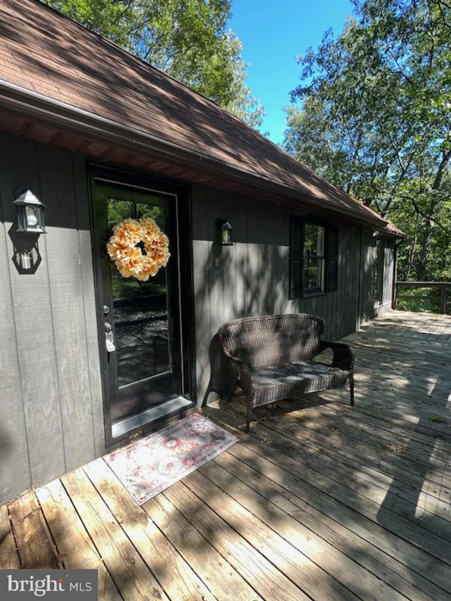 UPDATE:  High speed Fiber is now installed within the community and access to high speed internet should be available in November to customers. 

What a great place to create memories in your new WV cabin in the woods.  This 3 bedroom 1.5 bath home with 2 decks and a four season sun room allows plenty of space for your friends and family to come enjoy the fresh WV mountain air.  In the winter, the wood burning fireplace will be the perfect warmth you need on a cold snowy day.  Newly renovated with new flooring, paint, lighting fixtures, granite counter tops and stainless steel appliances this home is ready for you, the new adventurers.  Full unfinished walk out basement leaves room for storage, laundry, or customize to your needs for even more living space.  Each bedroom has a large closet, the kitchen has plenty of cabinet space, and the bathrooms have brand new toilets, vanities and flooring.  Enjoy the peaceful community of Morgan Woods that comes with private Cacapon river access and a river front common area for picnicking or a pickup game of cornhole.   Come TODAY to check out why everyone loves Morgan County for their own private peaceful escape!
Agent is Seller