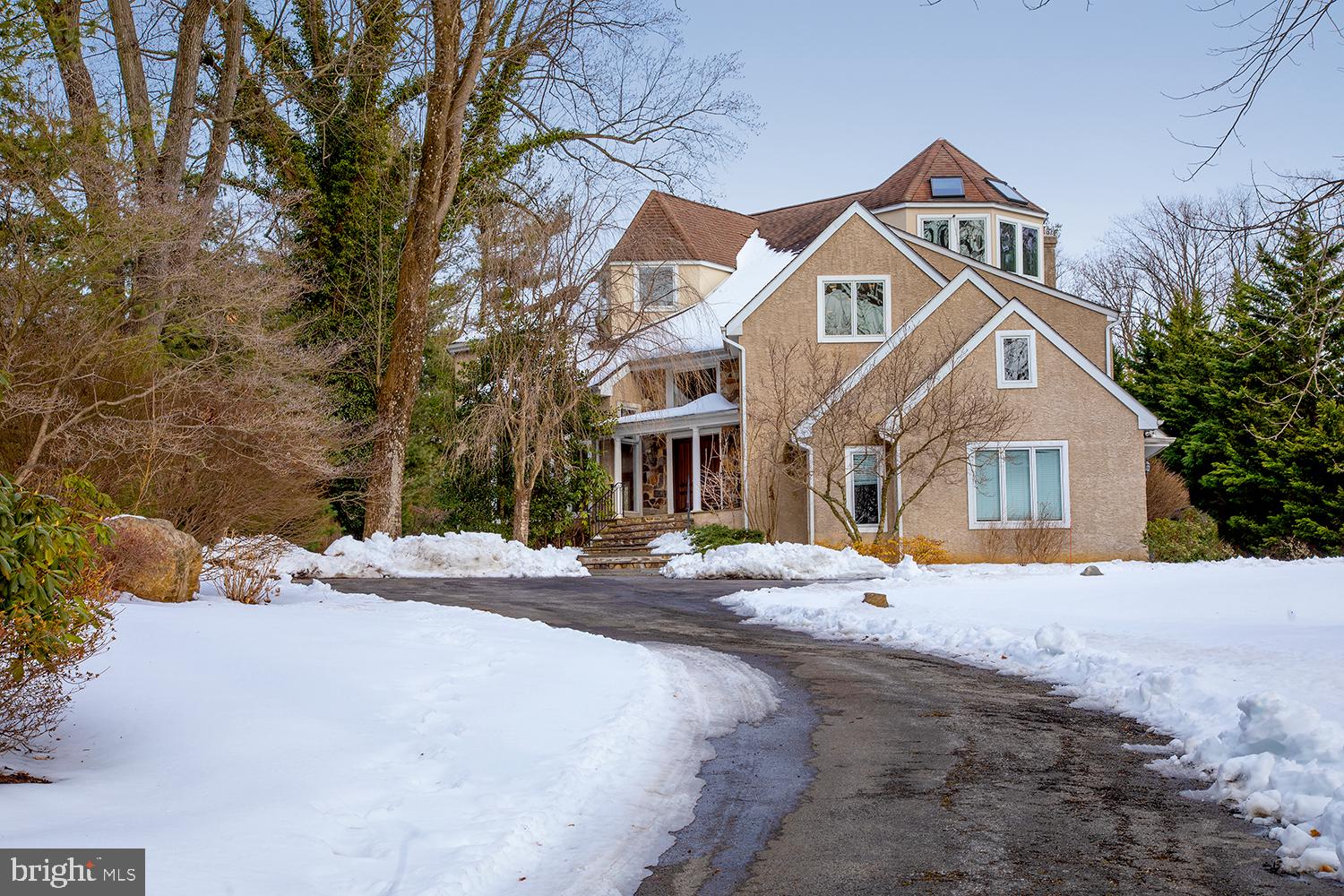 Enjoy the finest quality of living in any season in this magnificent 5 bedroom, 5.1 bath custom contemporary estate on 1.13 acres in prime Villanova! Gorgeous surroundings abound, with a vantage point atop a hillcrest and meticulous landscaped grounds showcasing natures beauty year round - from the blossoms of spring to the greenery of summer & brilliant leaves of fall. Your private oasis awaits down a long drive to a 3-car garage, beyond a gated entry with stately stone pillars. Outdoor pleasure and entertaining are unparalleled with a serene flagstone patio for barbecues, heated in-ground pool area with soothing hot tub, fire pit to cozy around on cool nights, plus lovely sitting/garden areas. The estate itself is an architectural gem, grand and meticulously updated yet very warm and welcoming. Elegance unfolds in the soaring entry foyer with an art feature and rich hardwoods flowing into gracious main rooms. Light floods the interiors from generous windows and skylights. A voluminous living room met by formal dining with gas fireplace and patio access afford comfort for guests and family gatherings. The host/cook will love the fabulous sun-bathed kitchen, the heart of the home, with wood cabinetry, granite counters, stainless steel appliances, and sky-lit breakfast area with exterior door. Adjoining is a built-in desk station and open family room with wood-burning fireplace for relaxing. Work remotely in the handsome office with built-ins, oversized windows and peaceful views. Convenient powder and laundry rooms complete the stunning main level. There is no better place to start and end your day than in the 2-story primary bedroom retreat with a charming electric fireplace and French doors to an outdoor balcony! A custom amazing dressing room with extensive storage and island, and incredible spa bath with soaking tub, glass shower, dual sinks and bidet enhance the luxury experience. Secondary bedrooms are as inviting, with new carpeting, Jack & Jill and full hall baths. A big bonus room with full bath and storage sits one floor above offering multipurpose space for a family room, studio, office, etc. Host parties or hang out on the finely finished lower level presenting a rec room, electric fireplace, wine cellar with antique WWII-era ships porthole, and walkout to the patio and pool. Here also are additional sleeping quarters with a bedroom and full bath. Updated neutral painting through out and 2 New HVAC units just installed. Perhaps best of all is the location, in walking distance to Radnor Trail. Plus you are in close proximity to excellent schools, Wayne village, the train, and major routes to the airport and Center City.