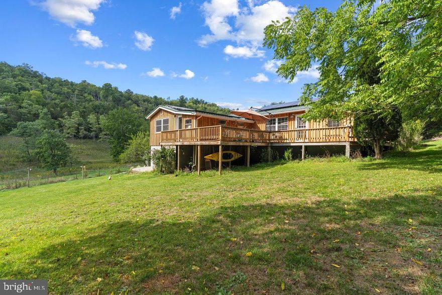 Welcome to your perfect farmette located in the wild and wonderful hills of Lost River, West Virginia.  With 4 bedrooms, 2 bathrooms, a solar array giving the new owner FREE ELECTRIC and 5 acres you couldn't ask for more.

This recently renovated homestead is perfect for the critter lover and entertainer alike. Complete with pastured livestock fencing, outbuildings, a mature orchard, and full-house solar system, you have everything you need to become a true homesteader. Or just enjoy the beauty of the land, the free electric, and the amazing community!

Featuring an extra-large en-suite main bedroom along with 2 bedrooms and 1 bath on the main level as well as a lower level bedroom, there is plenty of room for a large family or for entertaining weekend guests. Don’t need 4 BRs? The lower level would make a great game room, workout room, craft area or any space you desire. The updated kitchen with stainless steel appliances, ample stone countertops and walk-in pantry is a chef’s dream and flows freely into an open living/dining area. Enjoy cooking and entertaining simultaneously in this open welcoming living space.  

Step outside onto the expansive wraparound porch with views of the pasture and hills. Imagine sitting on the porch with your coffee or wine overlooking your horses or goats grazing in the fields below and listening to the sounds of your chickens clucking happily away. This home is a dream for entertaining with ample parking and outdoor space for yard games and BBQs. There is plenty of space for your future veggie garden and the orchard provides an abundance of fruit from apple, pear, and peach trees.  Imagine picking your own fruit right from your own backyard! If you are looking for a peaceful setting in the country, this farmette is the perfect retreat. 

Located in the popular LRVPOA subdivision where the roads double as walking paths and the neighbors always greet you with a smile and a wave, you feel a world away but have convenience all around.  10 min to Trout Pond Recreation center for swimming, fishing, and hiking and 20 min to Lost River State Park for trails, horseback riding, and mountain bike trails you are not far from all the outdoor activities the area has to offer.  Don’t miss the Lost River Farmers’ Market on Saturdays for your wine flight and baked goodies or a delightful meal at The Guesthouse at Lost River.  Also nearby is the Lost River General Store, Teets Meats, Lost & Found Pizza & Provisions, LRV Gym and H&T Farm Market.