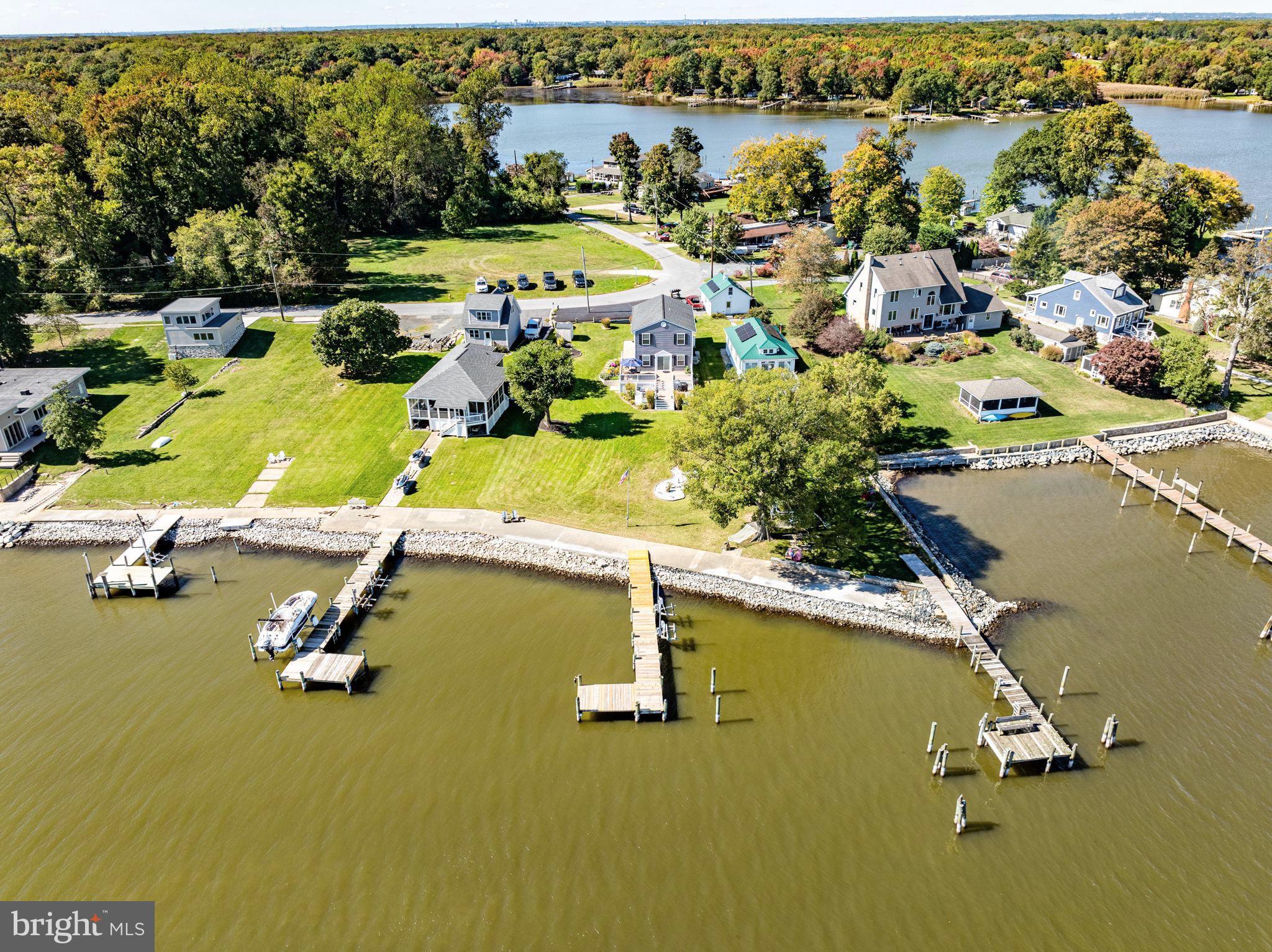 Beautiful waterfront Colonial home, perfectly set on a double lot totaling 0.46 acres, with breathtaking views of the Chesapeake Bay. Fully redone in 1998, this home combines classic elegance with modern updates. 6' x 72' pier, complete with jet ski lifts, invites you to enjoy the water. Inside, the eat-in kitchen is outfitted with stainless steel appliances. The inviting living room flows seamlessly to a large, two tier deck, perfect for relaxing and taking in the stunning waterfront views.
The upper level features three spacious bedrooms, including a primary suite with a primary bath featuring a soaking tub. The lower level is an improved recreation room with a convenient half bath. Recent updates include a roof that's less than five years old, new siding replaced 2-3 years ago, and a water heater that is under three years old. The property is equipped with a whole-house generator, ensuring comfort and peace of mind. This home offers the ideal blend of luxury, convenience, and waterfront living! Don't miss this beauty!
**Additional lot included .22 acres (possible buildable, Buyer must verify with county, Seller, listing agent and listing brokerage are not liable)