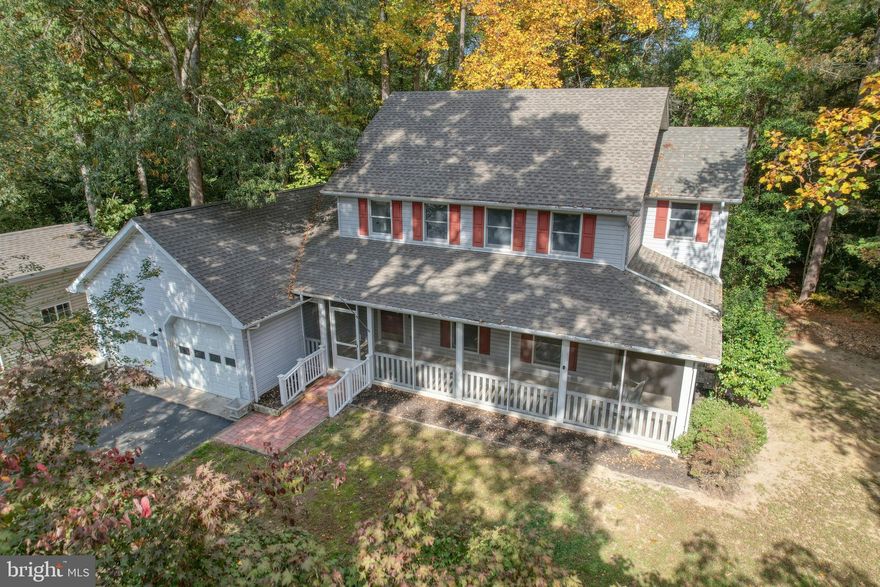 Nestled in the serene South Shores community, this charming traditional home offers a perfect blend of comfort and functionality. With four spacious bedrooms, three full bathrooms and basement, this residence is designed for both relaxation and entertaining. The inviting family room, complete with a cozy corner gas fireplace, flows seamlessly into the kitchen and dining area, creating an ideal space for gatherings. The upgraded countertops in the kitchen enhance the overall aesthetic, while the built-in appliances-including a microwave, dishwasher, and wall oven-make meal prep a breeze. Step outside to discover a picturesque 1.03-acre lot, adorned with mature trees.  Enjoy peaceful moments on the wrap-around screened porch or deck, perfect for savoring morning coffee or evening sunsets. The property also features an attached 2 car garage and an additional detached 16X24 garage with electric, heat and oversized, overhead door.  The lush surroundings and wooded views create a serene backdrop, making it a perfect retreat from the hustle and bustle of daily life. Located a short drive from the areas beach resorts and in the desirable Cape Henlopen school district, this home combines the best of both worlds-privacy and accessibility. Experience the warmth and charm of this delightful property, where every detail has been thoughtfully considered to create a welcoming atmosphere.