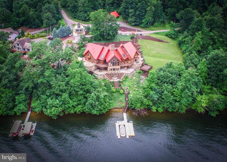 Emerald Oaks is one of Deep Creek Lakes most esteemed and unique lakefront estates. You’ll immediately notice the striking architecture, flowing open floor plan, and extraordinary finishes. Panoramic views and an abundance of natural light brings the outside in as you watch the day pass from an unobstructed view of the lake and mountain ranges. With six (6) oversized bedrooms, each finished in different wood species, and designed as your own escape within the 10,000+ foot masterpiece, it is truly one-of-a-kind. Whether you want to kick back next to the stone fireplace(s), enjoy some sun from the patio(s), or adventure out for a day on the lake… one thing is for sure, this lake escape checks all the boxes for those that are longing for the very best that Deep Creek Lake has to offer.