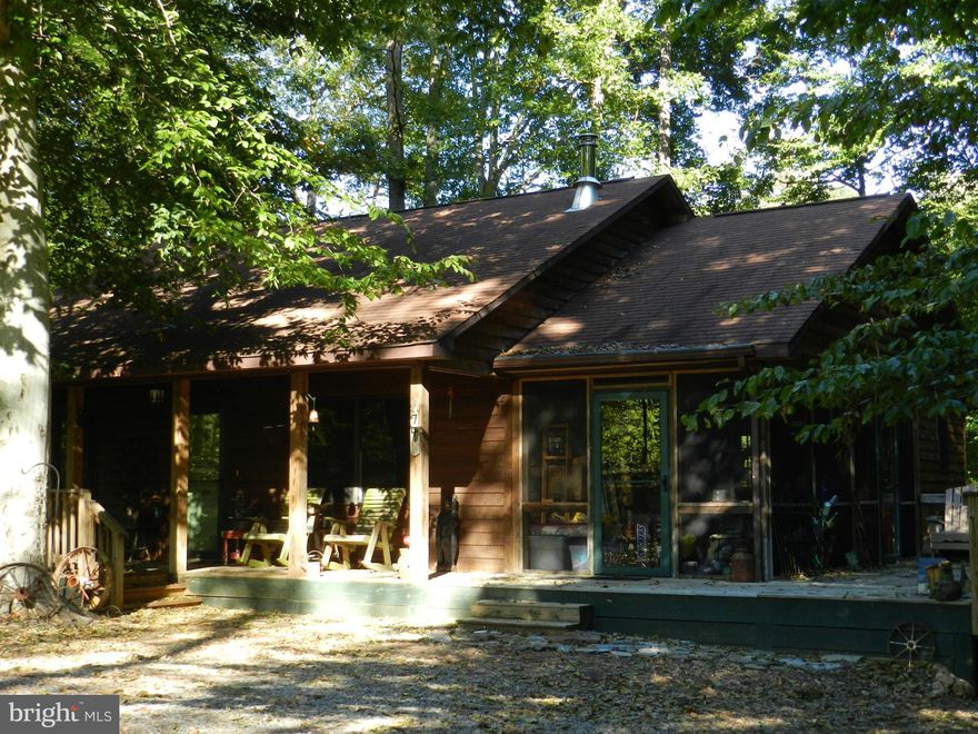 Relax & Enjoy! Country Cottage awaits you here-  tucked into the trees for privacy. Fenced rear yard for your pets, large rear yard for playing!  New Appliances, New Hot Water Heater, New Wood Stove, New Lighting & 5 New Ceiling Fans, New Jetted Tub, New Toilet, New Vanity, New Sinks, New Faucets, All Freshly Painted, Perfect Move In Condition -PLUS DEEDED BOAT SLIP  is all yours in this package!
