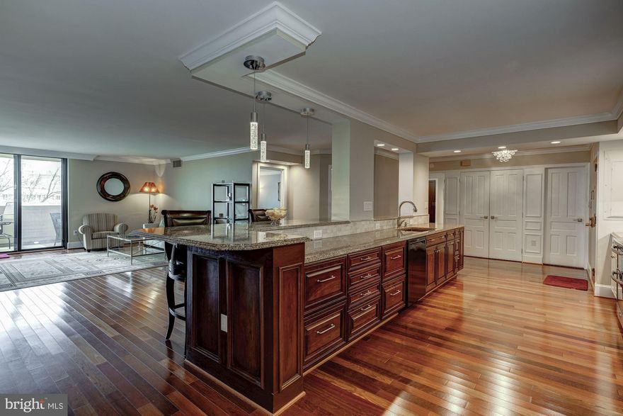 This spectacular unit has been completely renovated and reconfigured like no other unit in the building. As you can see from the photos, this home invites you to come home and unwind while cooking a leisurely meal that you can enjoy out on your balcony, weather permitting. It is also the perfect place to entertain because the guests have plenty of space to gather around without the kitchen ever being crowded. This Chef's kitchen boasts cambria counter-tops covering the 17 foot kitchen island, double oven, an Advantium convection microwave, wine cooler/beverage center, custom lighting, and enough counter space and cabinet storage for two chefs. The living room's handcrafted entertainment center has shelving for your favorite books and art pieces as well as a place for all but the largest TVs right above the fireplace. The guest room/study has a built-in desk and roomy closet.  There are Brazilian cherry floors throughout. Both full baths have marble heated floors and glass shower doors. The master bath has a double vanity sink and lots of storage for linens and toiletries. In the huge master suite is a walk-in closet with built-in racks, shelving and drawers. Your washer/dryer are conveniently located in the master bedroom in a separate closet. While others are commuting, you can enjoy spectacular views of the Washington Monument and other landmarks from your balcony, walk to Pentagon City Metro, restaurants, and shopping in 10 minutes. You can conveniently work out in the gym or lounge at the outdoor pool.  You will also have access to a handy private storage room fitted with Elfa shelving on the same floor.