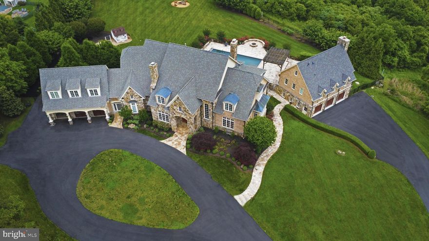 Welcome to 40524 Tim Tam Ct., the epitome of luxury living in one of Loudoun County’s most elite communities, Beacon Hill. Perched atop one of the highest points in the area, this stunning 10,500 sq.ft. estate boasts breathtaking 360-degree views that will leave you awestruck.

This custom-built masterpiece is designed for the ultimate entertainer, with a sprawling 3.76-acre lot that offers endless possibilities for outdoor living. The pièce de resistance is the resort-style backyard, complete with a 18x44 sparkling saltwater pool, exquisite travertine patio, and charming gazebo. Imagine lazy summer days lounging by the pool, or hosting unforgettable gatherings with friends and family.

The grand entrance sets the tone for this magnificent home, with a soaring two-story foyer that draws your eyes upward and out to the stunning vista views. The newly refinished knotty pine hardwood floors flow seamlessly throughout the main living areas, including the formal dining room with its natural wood-burning fireplace and ample seating for 14+ guests.  You’ll be mesmerized by the floor-to-ceiling windows as you walk into the formal living room overlooking the patio, pool and expansive views.  

The heart of the home is the gourmet kitchen, where culinary dreams come alive. With high-end appliances, including a 6-burner Viking stove and oversized Subzero refrigerator, this space is perfect for the discerning chef. The adjacent family room, with its custom wall-to-wall built-ins, is the ideal spot to relax and unwind or congregate around to watch the game.

The first floor also features a thoughtful butler's pantry, large walk-in pantry, and a convenient first-floor bedroom with full bath. The oversized office, sunroom, second laundry room and mudroom and adjoining breezeway connected to the upper three car garage complete the main level, offering ample space for work, play, and relaxation.  

The second floor is a serene retreat, with gleaming hardwood floors and tastefully trimmed coffered ceilings. The five spacious bedrooms, including a luxurious master suite with private balcony and stunning views, offer the perfect blend of comfort and sophistication.

The lower level is a haven for fitness enthusiasts, with a large 12x24 gym and rugged rubber floors. The expansive open floor plan, complete with a third stone and slate natural burning fireplace, is perfect for entertaining or family fun. Additional features include, custom chair rail and shadow boxing, a finished playroom, full bath, and ample storage space.

The crowning jewel of this estate is the custom-built pool house, a true entertainer's paradise. With its refined finishes such as two custom glass garage doors, full kitchen, multiple beverage and wine fridges, floor-to-ceiling stone fireplace and big air industrial fan, this space is perfect for hosting unforgettable gatherings. The pool house also features a full bath and a third set of washer/dryer for ultimate convenience.  Lower level three-car garage includes elevated ceilings, ideal for car enthusiasts, and a large workshop with ample space for tools and storage.  
Other luxuries include Lutron smart-home lighting system (interior and exterior), central vacuum and security system, new carpets, fresh paint inside and out.  Also don't forget about the highly anticipated Beacon Hill Golf Course scheduled for Fall opening!

Don't miss this rare opportunity to own a piece of paradise in Beacon Hill.   Schedule a showing today and experience the ultimate in luxury living!