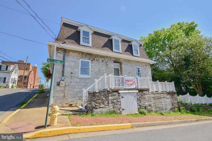 Built in 1795, this amazing building has been brought up to date with new paint, floors, roof, HVAC, and driveway. Featuring a large great room with wood ceilings and deep well windows that highlight the 20' thick walls. The old post office antique wall separates the main space from the mechanical room. There is a half bath on the main floor and wood stove as well. The second floor has a large office, conference room, library, and full bath. There are pull down stairs to the large storage room on the third floor. The private access driveway leads to a large private parking lot. This Martinsburg Historic property is unique and perfect as a professional office for discerning attorney, insurance, real estate, architecture, or engineering firm.