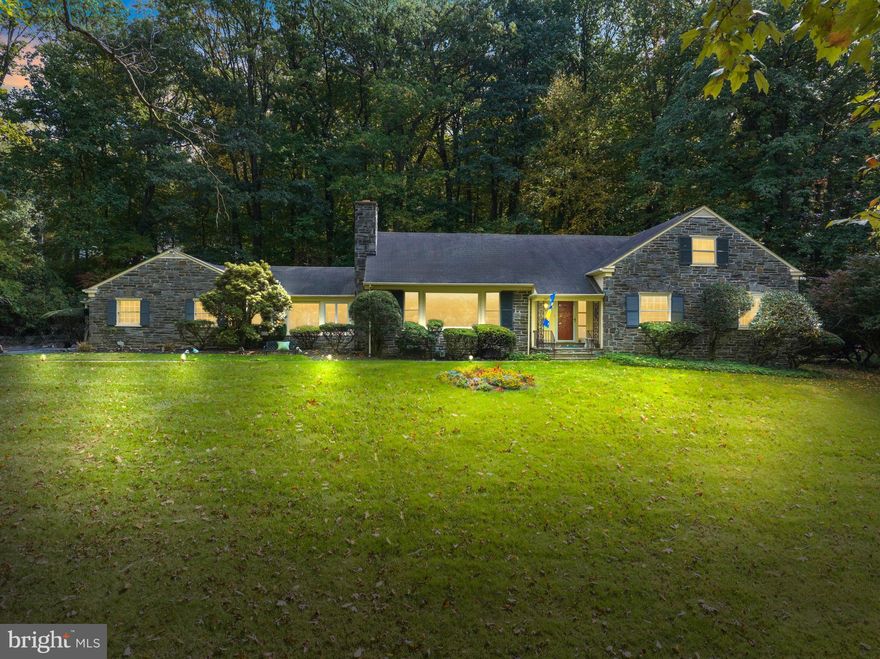 Welcome to 434 Pugh Road in Tredyffrin Township section of Wayne!  This charming stone 1 1/2 Story Expanded Cape Cod sits on a private premier 1.7 acre  wooded lot with lush lawn and mature landscaping in sought after neighborhood convenient to downtown Wayne, the Stratford Station, King of Prussia for shopping and restaurants and minutes from Valley Forge National Park. This home features unparalleled Living and indoor and outdoor entertaining spaces, timeless elegance and captivating charm.   This spacious home offers 5 Full bedrooms including a first floor primary bedroom suite, 4 1/2 baths, and  large light filled rooms including a large sunny vaulted cathedral ceiling Family room.  Hardwood floors are featured in most of the first and second floor of the home as well as beautiful deep windows sills.  The 1.7 acre lot may have possible subdivision possibilities. 
Enter the home from the covered front porch to the lovely Center Hall  with hardwood floors and crown molding opening to the inviting large fireside Living Room with wood burning fireplace with traditional Morgan Mantel with black marble surround, large picture window with outstanding views of front grounds and adjoins large  Formal Dining Room with chair rail, crown molding and another large picture windows overlooking rear grounds.  Dining Room connects to spectacular light filled Family Room with vaulted cathedral ceiling, French doors to lovely patio overlooking rear grounds and entrance to two car attached garage.  Dining Room also connects to updated Kitchen with breakfast area , white cabinetry and granite countertops and top of the line GE appliances and stainless steel bar sink and large walk-in  kitchen pantry closet.  Kitchen flows to large Mudroom/ Laundry room with addition cabinetry and outside  entrance to rear grounds and entrance to lower level/ basement. The first floor also features a charming study with built bookcases and Primary bedroom with primary bath and a large guest bedroom suite with attached large bath with soaking tub and stall shower and also connects to rear hallway.  Turned staircase leads to spacious upstairs with two bedrooms sharing a hall bath and private 5th bedroom suite with its own private bath with stall shower. Fifth Bedroom also Leads to large floored attic. The Lower  Level is unfinished  but provides lots of storage, a half bath and all the systems of the house.  Don’t miss this opportunity to live in this great neighborhood, with top rated TE Schools and convenient to major highways for commuting.