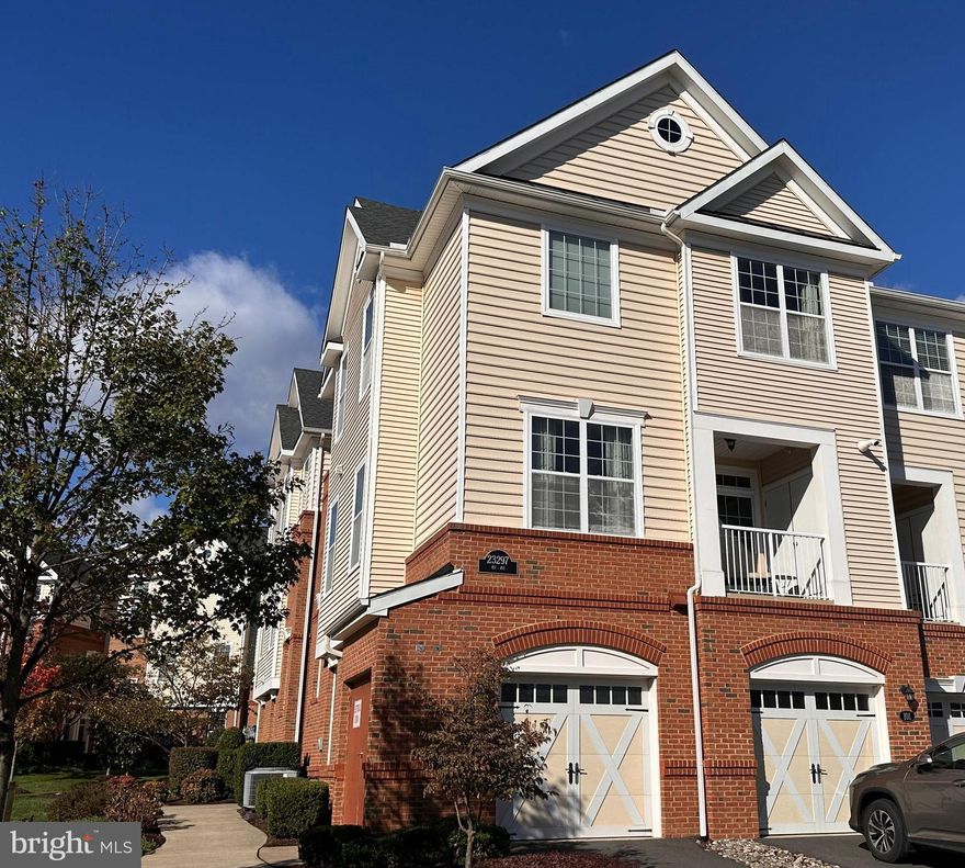 Modern Luxury Meets Everyday Comfort in the Heart of Ashburn!

Welcome to this stunning Ashbury Model townhome that perfectly blends upscale design with low-maintenance condo living. Built in 2017, this end-unit home is filled with natural light, tall ceilings, and designer touches throughout.

Step into the welcoming entryway on the first level, where hardwood stairs lead you up to a bright, open main living space that truly shows like a model. The main level features a spacious living room with a ceiling fan, elegant updated lighting throughout, and beautiful hardwood flooring that flows into a gorgeous gourmet kitchen. You’ll love the stainless steel appliances, granite countertops, porcelain farmhouse sink, gas cooking, tile backsplash, under cabinet lighting, and upgraded cabinetry. Just off the kitchen, a private balcony provides the perfect spot to enjoy your morning coffee or unwind in the evening.

Upstairs, both bedrooms offer private ensuite baths, including a luxurious primary suite with frameless glass shower, faux wood tile flooring, and granite-topped dual vanities. Plush new carpet (2025) ensures comfort underfoot, while hardwood continues through the upper hallway for a cohesive flow.

Additional highlights include an attached garage and private driveway, a security system with panels at the garage entry and in the primary suite, and upgraded light fixtures in the kitchen, dining area, powder room, and bathrooms.

Enjoy access to three community clubhouses, multiple pools, fitness centers, walking trails, and playgrounds—plus a prime location just minutes from One Loudoun, Brambleton Town Center, and the Silver Line Metro.

This exceptional home offers the perfect balance of sophistication, comfort, and community—modern living at its finest in the heart of Ashburn.