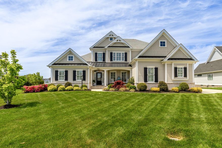 Attention to detail is extraordinary in this stunning coastal-style residence built by Oak Construction, one of Delaware’s most respected custom home builders. Built in 2021, this exquisite home offers a seamless blend of luxury and comfort with 5 spacious bedrooms and 4.5 beautifully appointed bathrooms.
Step inside to an inviting open floor plan featuring crown moldings, recessed lighting, thoughtfully designed living spaces, and beautiful 7" plank engineered hardwood floors throughout the main living areas. The gourmet kitchen is a chef’s dream, showcasing Thermador stainless steel appliances, including a 48" cooktop with double ovens and grill, microwave drawer, and built-in side-by-side column refrigerator and freezer. The oversized 6' x 9' island offers seating for seven and is complemented by Calabria quartz countertops and inset cabinetry, creating the perfect space for everyday living and entertaining.
The family room, anchored by a gas fireplace with custom built-ins, enhances both warmth and character. Stacking glass doors extend the living space into a three-season room, offering effortless indoor/outdoor living.
Retreat to the luxurious owner’s suite featuring two walk-in closets/dressing rooms with a linen closet and professionally designed closet systems. The spa-inspired primary bathroom showcases marble 8" hexagon floor tile with radiant heated floors, a large marble-tiled shower with a corner seat, marble countertops, and a stunning tiled accent wall extending from the vanity to the ceiling behind the mirrors.
Additional bedrooms offer ample space and comfort throughout, and all closets throughout the home feature professionally designed closet systems.
The recently finished lower level provides exceptional flexibility for recreation and entertaining, featuring a spacious game room, dedicated fitness room, and a full bathroom with marble tile flooring and a marble-tiled shower. Exterior access adds additional convenience and functionality.
Outside, enjoy adjoining open space with serene pond views. Relax on the expansive hardscape patio or take advantage of the community amenities, including a pool and fitness center. Professionally landscaped grounds include underground irrigation.
With an attached side-entry garage and ample driveway parking, this home is designed for convenience and elegance. Experience the exclusive lifestyle this remarkable property offers, where luxury meets comfort in every detail.