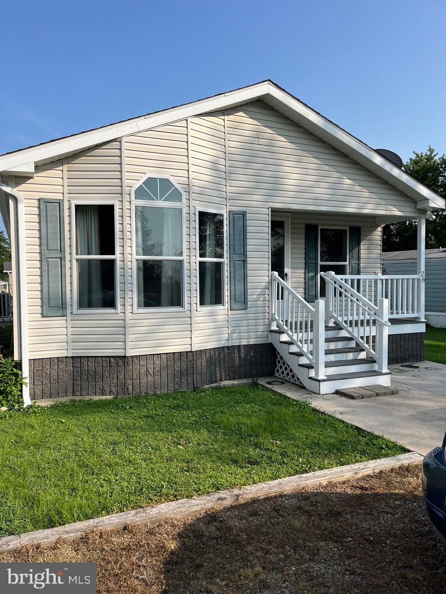 Beautifully maintained one owner home - shows like new.  This is a Pine Grove manufactured home constructed with 2x6 insulated walls, insulated floors and ceilings. Cottage style end entry with covered porch. 5/12 pitch roof, stone skirting, on concrete slab. Open floor plan with large living room,  open arch to separate dining area both  filled with natural light from  thermo-pane windows with blinds and drapes. The kitchen is accessible from the dining room and the living room allowing good traffic flow for gatherings. Kitchen has an abundance of light oak cabinet space, breakfast bar, and all appliances. The primary bedroom has an attached bathroom with walk-in shower and ample storage cabinets. Two additional bedrooms. All rooms feature ceiling lighting. Utility room with cabinets and outside entrance  to full length sidewalk leading to parking area and utility shed.
This home is located in a land lease community. All buyers must be approved by the Community management prior to purchase. There is a no pet policy and all applicants are subject to a criminal background check as well as credit check.