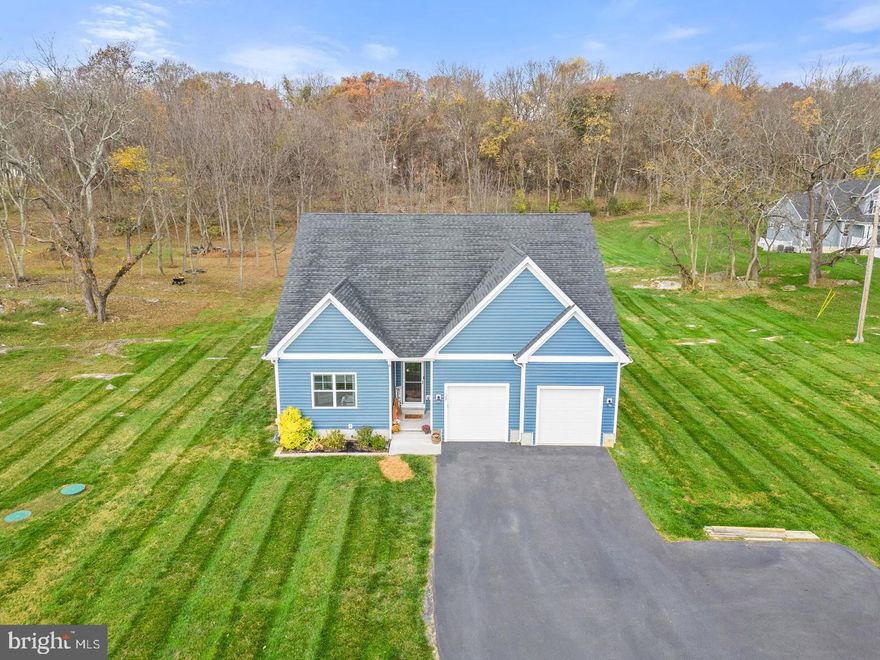 This charming property encompasses 5 acres for your comfort and privacy, including an acre of densely wooded area at the rear. The heart of this home is its centralized kitchen and family room, with stunning cathedral ceilings and an inviting open floor plan. The family room exudes warmth with a corner stone gas fireplace, complete with a hewn log mantle and shiplap surround. The kitchen is equipped with granite counters, a walk-in pantry, deep farm sink, breakfast bar, and ample cabinet and countertop space, all conveniently connected to the breakfast room. The primary bedroom boasts tray ceiling and dual walk-in closets, leading to an impressive en suite bathroom with a rustic barn wood accent wall and modern lighting above the double-sink vanity. The beautifully tiled flooring guides you to the spacious walk-in shower. Both spare bedrooms offer generous dimensions, each with large closets and ceiling fans. Hardwood Flooring on the main level and upgraded carpet throughout. Perfect for entertaining, the ample rear patio leads to an additional paver patio with outdoor wood burning fireplace. Just a couple steps away is the perfectly placed playground with playset.