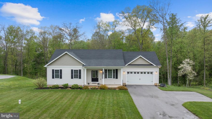 LIKE NEW and only 6 years young, this beautifully maintained home on nearly 3 acres offers modern comfort with timeless style. The open-concept layout is anchored by a stunning vaulted-ceiling living room featuring a gorgeous stone fireplace, creating the perfect space to relax or entertain. The gourmet kitchen is equipped with granite countertops, stainless steel appliances, and a spacious eat-in area that flows seamlessly to the deck, ideal for indoor-outdoor living. Three generously sized bedrooms on the main level. The fully finished walk-out basement adds incredible versatility with a full bath, perfect for guests, a home office, or additional living space. Thoughtfully designed and move-in ready, this home checks every box. Please contact Olivia with all questions!