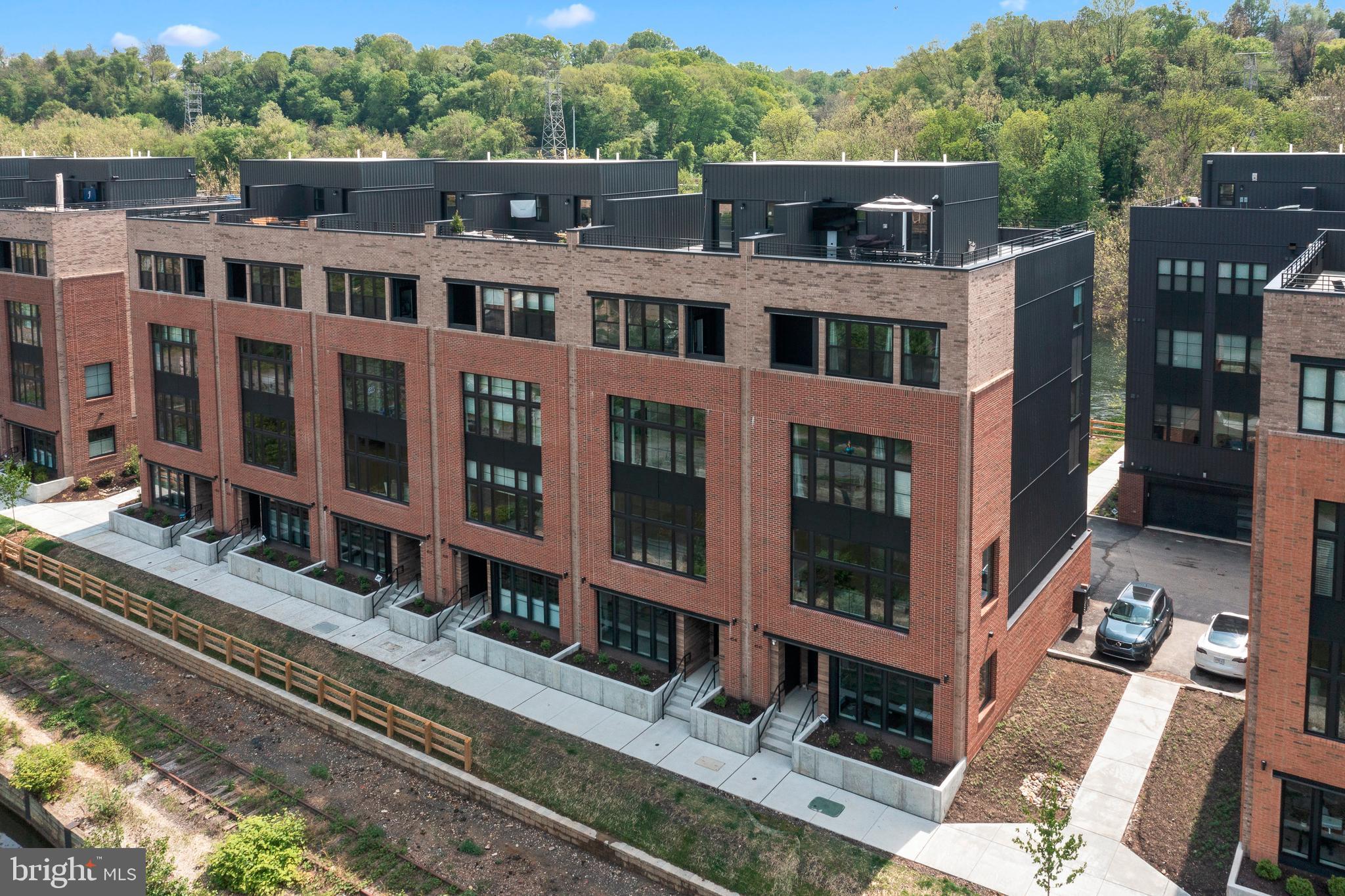 Welcome to 4543 Riverside Way, the Loire model of The Locks, Riverside Townhomes Manayunk set between the scenic Schuylkill River and the historic Manayunk Canal. Take a short walk across the canal, and you’re in downtown Manayunk. Enjoy unique restaurants and bars, and a wide array of boutiques. Visit a local gallery. Go for a run on a trail. Inside this EnergyStar Certified home, you’ll find wide-open floorplan, chef-inspired kitchen and all the latest appliances, features and finishes. The Lorie, is the largest model featuring 4 bedrooms, 3.5 bathrooms and private elevator for easy access to all floors. This end unit is spacious and sun drenched providing the best water views from ALL levels. The gourmet kitchen features Wolf appliances, sub zero refrigerator, upgraded quartz countertops and large island. For convenience and entertaining, wet bars can be found in the living room and the master bedroom suite. The home flows with American Scraped Hickory hardwood floors gleaming throughout. The 4th floor features a private owners oasis with den/study. This level offers his and her closets with a large on suite with double vanity, custom stall shower and soaking tub. Enjoy the outdoor sitting room off the master suite with your morning cup of coffee. The homeowners spared no expense and have an endless list of upgrades. This home is a Smart home. A home automation system that allows you to control home attributes such as lighting, climate, entertainment systems with a touch of a button in an app. Additional features are high efficiency tankless hot water heater and high efficiency two-zone HVAC system and 2 car garage. There is a 10 year tax abatement that has 9 years and 7 months remaining. From the expansive private rooftop terrace with Trex decking, you can enjoy the spectacular water views from every angle. This home is truly one a kind!