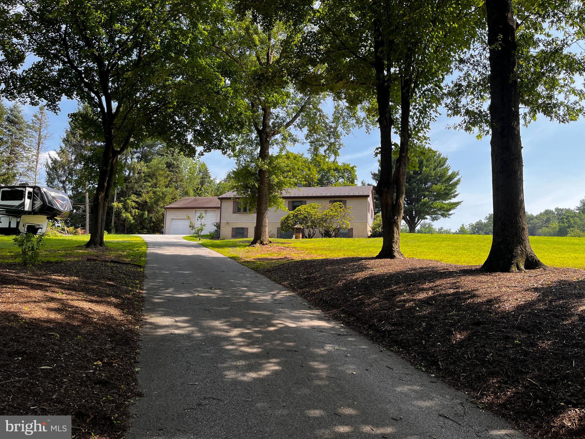 Come and see this raised rancher sitting on 2.2 acres in beautiful Chester County in the Owen J. Roberts School District. The home features a kitchen area with a large island open into the dining and living areas. Dining area features french doors opening on to a Trex deck , and outdoor hot tub. Also, outside there is a large patio made with Travertine Stone with electric and propane hookup. The inside living area has a wall of custom built cabinets for yourTV and storage needs. All upper floor windows and doors were replace in 2023 by Renewal By Andersen. Down the hallway there are 3 bedrooms all with new carpet. Also a full bathroom with tub and shower with acess from the hallway or the main bedroom. All the hardwood flooring in the living area, dining area, and hallway have recently been refinished. New central air conditioning was installed in 2023. A new Energy Star Steel Roof with a lifetime warranty was installed in 2010 on the house. The lower level finished living space offers cabinets and sink for all your entertaining needs. Freshly painted and all new carpeting has been installed except one room is tiled. The extra rooms can be used for an office or workout room. There is also a full bathroom. The lower level is loaded with possibilities. The large utility room and laundry room can be used for extra storage. There is no air conditioning in the lower level, but it stays cool. The large pole building/garage has so many opportunities with 3 bays, depending on the vehicle size you could get more than 3 vehicles inside. The middle bay has an industrial 10' X 12' garage door, with the other 2 bays are 9' X 8' with all having automatic garage door openers. There is also a window air conditioning unit, propane heat with tank owned, and walk up stair storage area. A shed filled with outdoor tools, snow blower, salt spreader is also included. Schedule your showing today!