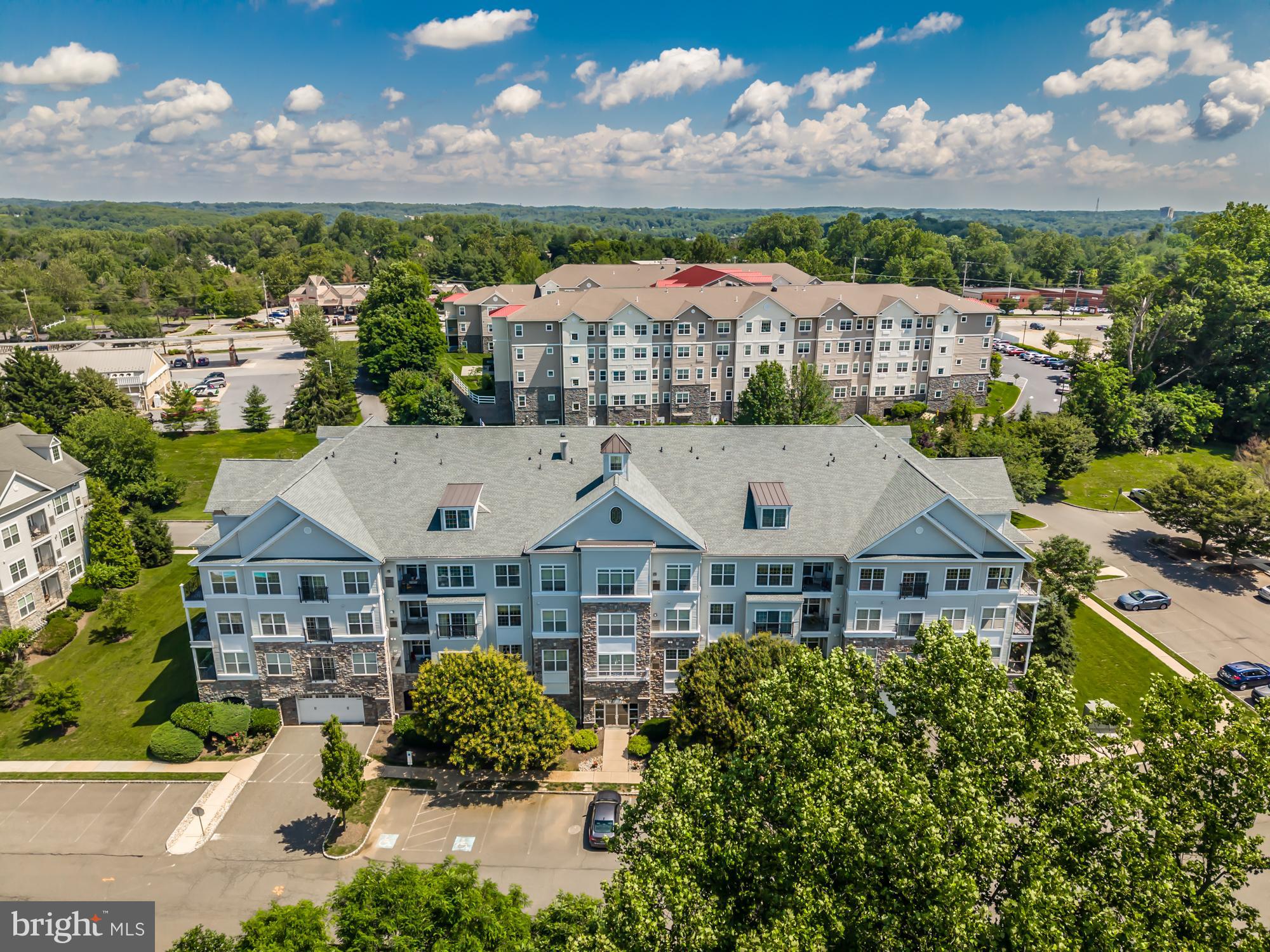 This exceptional three-bedroom, two-bath condo with a spacious loft is one of the largest end units in the sought-after Hollow at Fox Valley community and a rare opportunity you won’t want to miss. Step inside to soaring cathedral and nine-foot ceilings that create an open, airy, feel throughout, complemented by an inviting floor plan that welcomes light into every corner. In the living room, a vaulted ceiling, and a wall of double-hung windows frame beautiful tree-top views—also enjoyed from your private balcony. The professionally designed kitchen is a dream for any home chef, featuring granite countertops, updated stainless steel appliances, warm cabinetry, and a breakfast bar perfect for casual dining. Just off the kitchen, a spacious dining area provides the ideal setting for hosting guests or gathering with family. The luxurious primary suite is a true retreat with a vaulted ceiling, two generous closets, and a large ensuite bath complete with dual vanities, a stall shower, and a jetted soaking tub. Two additional bedrooms—one featuring a custom-built Murphy bed—offer comfort and versatility, along with a well-appointed second full bath. Upstairs, a bright and flexible loft makes the perfect den, home office, reading nook, or creative space, and includes two large storage rooms for added convenience. Additional features include secure elevator access to all floors, an underground parking garage with one assigned space, and a private storage locker. Community amenities enhance the carefree lifestyle of this convenient community with a swimming pool, clubhouse, walking trails, and beautifully maintained landscaping. All of this, just minutes from the Wawa train station, local shopping, dining, and easy access to Philadelphia and Wilmington. Don't delay, schedule your private tour today!