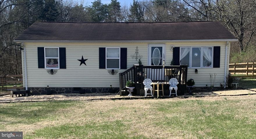 This beautiful updated 2-bedroom, 1-bath home is situated on a peaceful 1-acre lot.  This charming property features modern upgrades throughout with a warm and inviting feel.  Inside, you will find a bright open layout with updated flooring and a stylish kitchen complete with updated cabinetry, countertops and appliances.  Custom made island with seating.  The renovated bathroom offers contemporary fixtures and a clean modern design.  Both bedrooms are comfortably sized with plenty of natural light.  This home has a bonus room that is currently being used as a master walk-in closet and storage.  Furniture and televisions are negotiable.  Outside, the spacious 1-acre lot provides plenty of outdoor living, gardening, recreation or future expansion.  Property features a newly installed partially fenced area.  Deck with canopy that conveys.  Enjoy the privacy and tranquility of country-style living while still being conveniently located near local amenities.  This move-in ready home is perfect for first-time buyers, downsizers, or anyone looking for a peaceful property with modern updates.