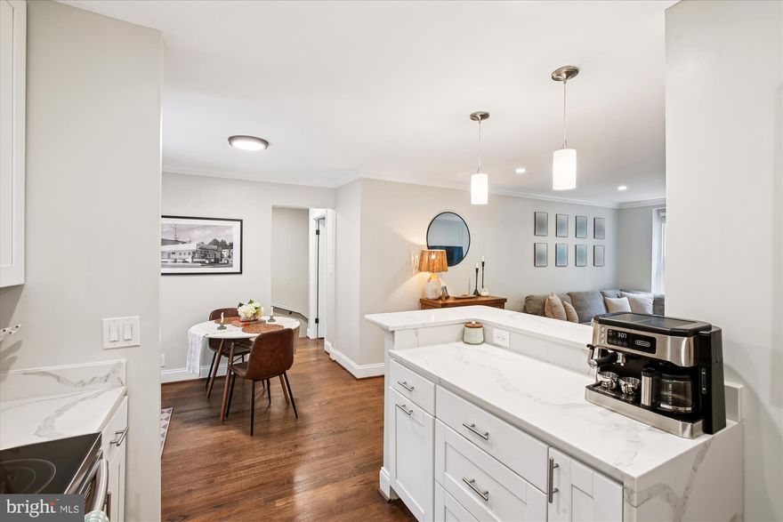 Beautiful 2-bedroom, 2-bathroom Barcroft model home nestled in Fairlington Villages! This light-filled corner unit spans nearly 1,500 square feet over two living levels! The spacious living room features richly stained hardwood flooring, designer-inspired touches including wall moldings, recessed lighting, & crown molding. The renovated open kitchen is accented with white soft-close Shaker-style cabinetry, quartz countertops, subway tile backsplash, stainless steel appliances, recessed lighting, & a breakfast bar with pendant lighting. The separate dining area provides access to the private rear balcony & fully fenced patio, making this home perfect for entertaining! The main bedroom features a modern ceiling fan with overhead light, a large walk-in closet, & windows on two walls! The updated full bathroom features a stone-topped vanity, patterned tile flooring, & a modern subway-tiled shower with niche shelving. The lower level features updated flooring, recessed lighting, & crown molding throughout the recreation room with under-stair storage closet & bonus room. The incredibly spacious bonus room includes a huge walk-in closet, access to the utility/laundry room with a full-sized washer & dryer, & its own private entrance. A remodeled bathroom accented with a barn door entry, stone-topped vanity, corner glass-enclosed subway-tiled shower, & hexagonal tile flooring completes this home. Other home features include newer vinyl windows (2021) & easy parking right behind the home. Fairlington Villages residents enjoy six pools, lighted tennis courts, tot lots/playgrounds, walking paths, & more! Conveniently located near I-395, as well as the shops and restaurants at The Village at Shirlington, West Alex, Del Ray, & Old Town Alexandria.