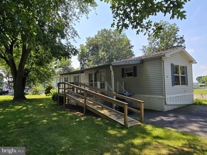 Nice 2-bedroom 2 bath mobile home on a corner large corner lot.  Built in ramp and grab bars in the bathroom, Eat-in kitchen with nice cabinets.  Laundry off the kitchen with washer and dryer.  LVP flooring in the kitchen and living room and bathrooms.  New carpeting in the bedrooms.  This mobile is very nice condition.  Nice shed goes with the mobile.  Must be Park Approved.