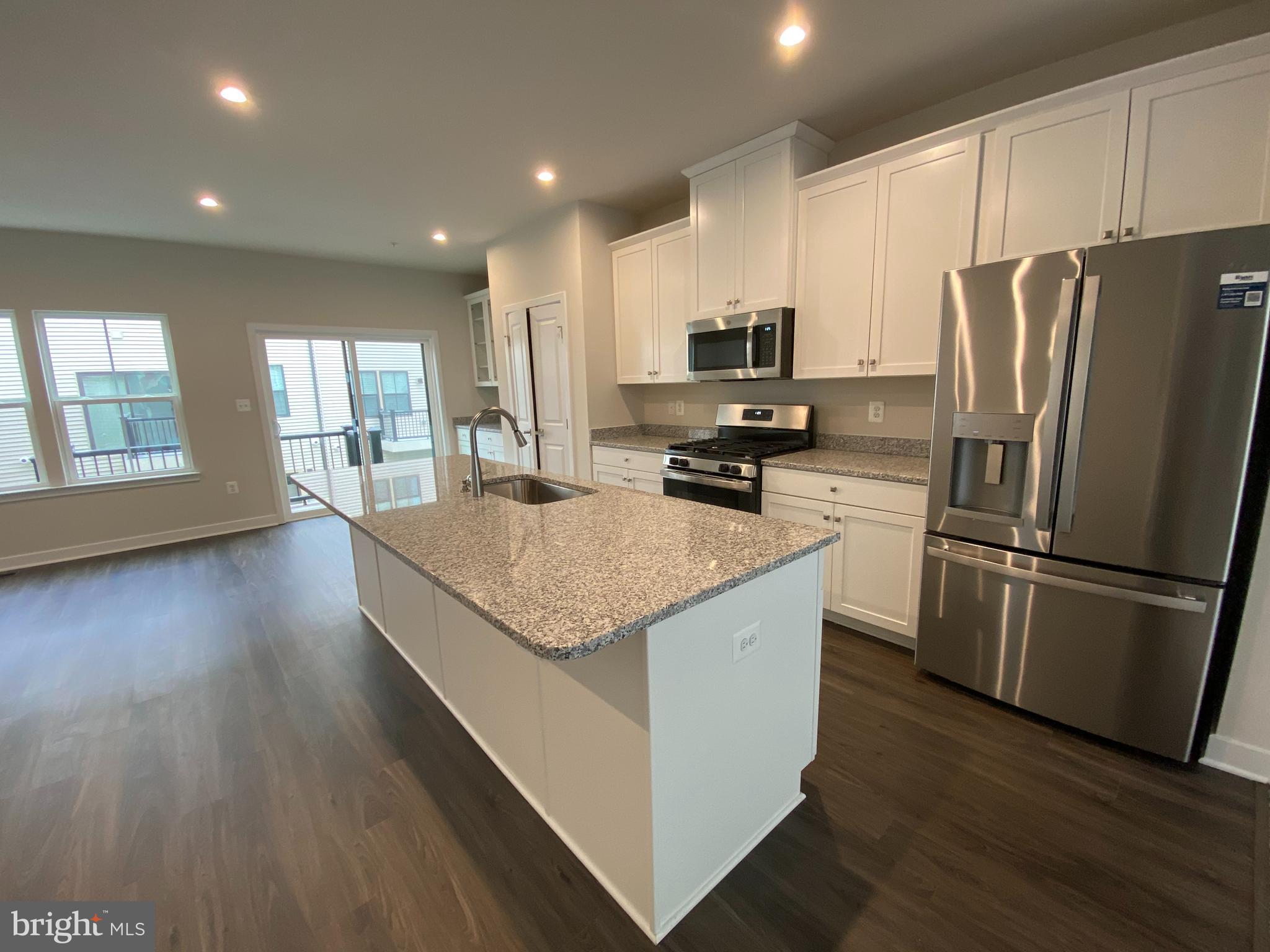 This is a fabulous home with 4 spacious levels. The home has an open concept floor plan with a gourmet kitchen and a ROOFTOP DECK to boot! The Primary Suite on the 3rd Floor features a soaking tub, separate shower and a nice size walk-in closet. Two-car garage with an EV charger! You have the option to use the pre-installed ring camera. Great community, short walk to Metro. Welcome home!