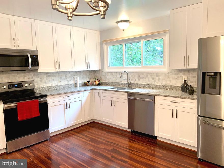 NEW PRICE! Location! Location! Location! Magnificent 5BR,  3.5BA  home with an over-sized two-car garage in a sought-after school district. Four-level of living spaces can accommodate a large family in a quaint community. This very unique contemporary style home is light-filled and earth-friendly. It utilizes space efficiently and offers room for customization. Here are some of the highlights for this beautiful and well-maintained home: *Topnotch school cluster-- Walking distance to Wootton High School, Robert Frost Middle School, and Lakewood Elementary School.  *Steps to the playground, community pool, tennis courts, parks, and Millennium Walking Trails. *Minutes to shopping, restaurants, retail, a 270 highway exit, Rockville Town Center, and Shady Grove Hospital. *Gleaming hardwood floors throughout the property except for the foyer, bathrooms and  laundry room.    *Newer Casement windows offer more durability, reliability, and energy efficiency. Picture windows to the green tree-line backyard offer respite from busy days. *Updated gourmet kitchen with brand new soft-close cabinets, granite countertops, and stainless steel appliances. *New recess lights in living room and dining room. *Renovated bathrooms. *Freshly painted interiors. *New energy-efficient water heater. *Central Vacuum at all levels. *4 spacious bedrooms on the upper level. *MBR with private bathroom and walk-in closet. *Walkout lower level with the 5th bedroom and a full bathroom, opens to the flat backyard with a wildlife-proof vegetable garden. The bedroom in the lower level can easily become a home office. *Plenty of storage spaces in garage, crawl space, and a storage area between levels. *Paved brick driveway is maintenance-free. *Thorough insulation on attic and storage areas. This unique and great home is A MUST SEE! Check on the 3D Virtual Tour!