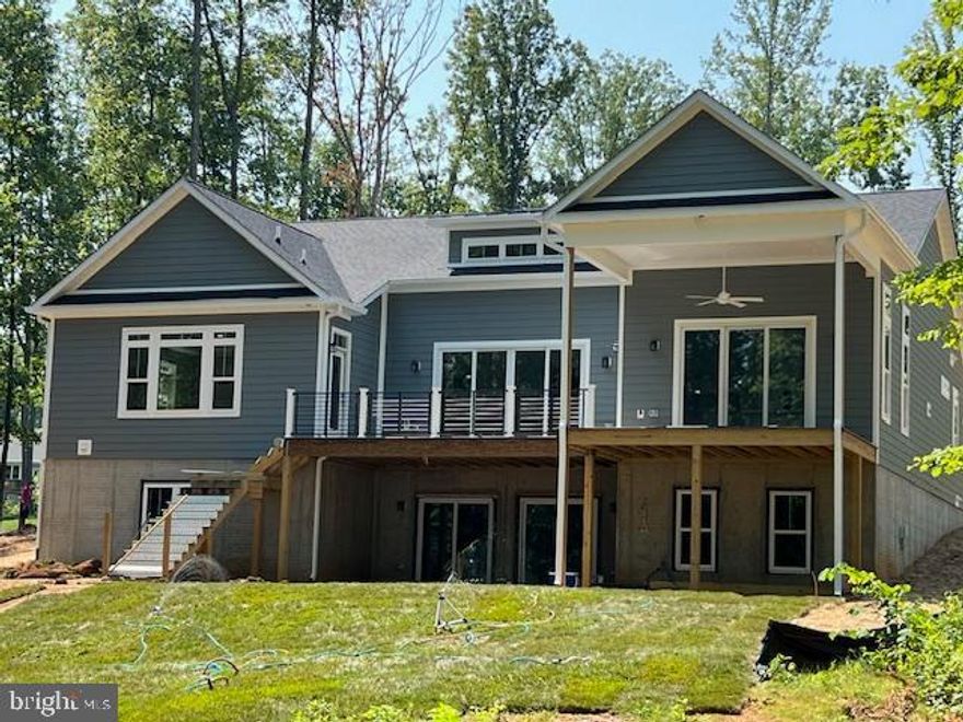 Waterfront, new construction offers, amazing views with all the comforts of home.

Starting with the bright open foyer, your first glance is of the tranquil waters at Lake Anna.
Large open foyer, main level living - Bedrooms with on-suite, filled with light, ceiling fans, and closet space. Each bathroom offers upgraded tile, quartz countertop, 8 inch spread Moen faucets, and painted cabinets.

Upgraded trim package throughout, wooden shelves, ceiling fans, and ample recessed lighting.

As you make your way into the open Family room, kitchen and Breakfast area tall 14-foot ceilings and active bay window, letting the natural beauty of Lake, indoors.

Multi Sliding rear doors, open to large rear deck and covered porch area.
Rod and rail TREX system offers open view of the lake.
Floor to ceiling stone fireplace, walk up dry bar with mini fridge and exotic quartz countertops, Tile Backsplash offers a fun yet upscale experience.

Your kitchen is fully equipped with two ovens as well as third; confection microwave. Gas cooking on your six burner stove with direct vent  hood,  beautiful stacked white cabinets.
Large pantry with wood shelves.

Your owner suite offers starts with a Tray Ceiling with LED lights, fixed picture glass window overlooking gorgeous Lake Anna.

Your walk-in shower offers decorative tile and frameless shower glass. Private setting allows for picture window over your freestanding tub, and two vanities and private water closet.

The entertaining area doesn’t stop with the open floor plan. Walkout basement is finished with large rec room, second fireplace surrounded by stone, and wet bar with overhang for all of your guest.
Smart TV will be installed as well as 3 other TV locations - pre-wired, so you don’t miss any of the games this fall!

Your lower level is equipped with two bathrooms a large bedroom with walk-in closet. 

Heating and cooling your home will be more efficient with the two-zone dual fuel system (main level). Your house is equipped with two hot water heaters and both HVAC units are in the basement for easy servicing.

Outside: 3 car garage, James Hardy siding, stone water table, EV charger, large mudroom with direct access from the lake.

A large concrete patio, outdoor shower, and private cove await.

Your custom boat dock is in the process of being completed.
They double-decker single slip dock with composite decking offers expensive use of Lake Anna and the most gentle grade you can find.

Lighthouse point community offer luxury living on the private side of Lake Anna.