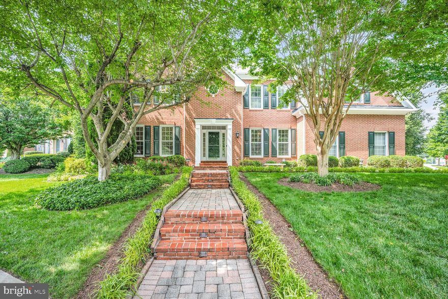 FOUR FULL LEVELS OF LIVING! Grand and Stately Brick Front Colonial with Dramatic, Open Floorplan!  Formal Living and Dining Room open to a sunlit Two Story Family Room punctuated by Woodburning Fireplace.  French Doors lead to a private Home Office with Built-Ins (and a safe). Hardwoods throughout. Tablespace Kitchen with Granite and SS appliances and main level Laundry (extra fridge conveys!). Graciously sized Bedrooms, Primary features sitting area and Bath with Soaking Tub.  Finished Attic level boasts an additional Bedroom and Full Bath with Steam Shower.  Lower Level offers ample Entertaining space, Storage, Gift Wrapping Room and Full Bath.  Large Deck with Outdoor Kitchen and Brick Patio, both  buffered by  Privacy Trees. Oversized Garage and Underground Sprinkler.