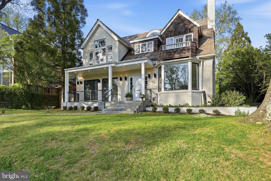 Sunset views, timeless elegance, and a true Palisades neighborhood lifestyle. This exceptional Palisades residence blends a welcoming, traditional floor plan with refined contemporary style—an increasingly rare opportunity in one of Northwest DC’s most close-knit and coveted neighborhoods, anchored by the beloved Palisades Recreation Center. Set on a generous quarter-acre corner lot, the home is filled with light and designed to live beautifully every day while effortlessly hosting memorable gatherings. From the front porch, enjoy sweeping sunset views toward Virginia and the Potomac River in all four seasons—a truly special vantage point. The 5-bedroom, 4-bath home lives large across four thoughtfully finished levels and has been superbly renovated with high ceilings, rich mouldings, custom trim, and hardwood floors throughout. At the heart of the home is an Italian gourmet kitchen with European Oak cabinetry, equipped with Sub-Zero, Miele, and Bosch appliances, Italian countertops, and an oversized breakfast bar—perfect for everything from weeknight meals to entertaining on a grand scale, all overlooking the serene rear gardens. The family room invites relaxation with custom built-ins and a cozy gas fireplace, while the elegant dining room with bay window and gracious living room with wood-burning fireplace offer timeless spaces for gathering. A rare main-level bedroom suite with full bath provides ideal flexibility for multigenerational living, guests, or a sophisticated home office. Upstairs, the primary suite is a true retreat, featuring a spacious bath and beautifully appointed dressing room. Two additional bedrooms and a full hall bath offer versatility for family, guests, or home offices. The top level provides excellent storage or an ideal au pair suite. The lower level expands the home’s flexibility even further, with a potential studio or au pair suite, private rear access, kitchenette, family room, full bath, laundry, and abundant storage. Step outside to an expansive rear deck leading to a private, fenced, landscaped backyard—a peaceful oasis equally suited for quiet mornings or embassy-sized entertaining. An oversized, rear-load two-car garage offers additional storage above and potential for an ADU (check zoning). Note EV charger installed inside garage. Additional highlights include two-zone efficient HVAC for comfort and reasonable utility costs, plus recent updates including 2026 interior and exterior painting, refinished floors, and new carpet. Perfectly positioned for an active, connected lifestyle: enjoy daily walks along the Capital Crescent Trail, C&O Towpath, Potomac River, and nearby parks, stroll to Black Coffee and Starbucks, neighborhood restaurants, and shops, and take part in the weekly Palisades Farmers Market and annual Fourth of July parade. Minutes to downtown DC, Georgetown University, American University, Maryland and Virginia commutes, top hospitals, and shopping. Zoned for Key Elementary, Hardy Middle, and Wilson High. Easy access to the Capital Crescent trail from the house, and also to the C&O Canal and Towpath. This is more than a house—it’s a rare Palisades lifestyle opportunity. Come experience it in person.