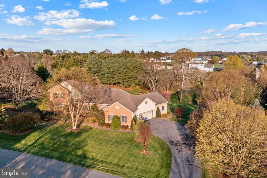 WELCOME to this stunning custom home in Bradford Estate on idyllic 2-acre lot. Located on a quiet cul-de-sac, this home sits on one of the larger lots in the neighborhood and offers beautiful views of the private back yard. Whether you love nature, outdoors sports, entertaining, gardening, raising chickens, this property is ready for your dream lifestyle. The heart of the home, with the open floor layout is bathed in morning light. Prepare a cup of tea or coffee and cozy up on the patio for your morning ritual. With an expansive deck, the back of the home faces an emerald gentle downhill. In the winter, the quiet contemplation is replaced by squeals of delight as you sled down in the snow. Back inside, the two-story great room, with floor to ceiling brick wood-burning fireplace, is the favorite gathering spot for everyone. Open to the breakfast room, gourmet kitchen, dining area, and deck, entertaining is effortless and fun. The recently updated gourmet kitchen with 5-burner propane gas cooktop (2023), cooktop downdraft (2023) wall oven and microwave, refrigerator (2023), granite countertops (2024), reverse osmosis filters (2023), touchless faucet (2023) is the delight of the owner who is a chef in training. And the view of the blooming rhododendron....mesmerizing. The primary bedroom suite on the main level is private and your peaceful retreat at the end of the day. The pink leaf Beech tree provides privacy and a beautiful view right outside the window. The large walk-in closet provides ample space. Step right into the primary bathroom and prepare to be pampered. A large jacuzzi tub is delight for those who love to end the day with a relaxing soak. A walk-in shower and large double vanity complete the space. With a laundry room on the mail level and access to the garage, this home is designed to offer comfortable main-level living. On the upper level you will find two bedrooms, each with its own walk-in closet, and a full bathroom. Each bedroom offers a different view, with the full splendor of the pink leaf Beech tree outside one bedroom window and the sprawling back yard view outside the other bedroom window. The lower level offers a versatile space that is configured as a fourth bedroom with its own steam-shower full bathroom, wet bar with reverse osmosis filter (2023), and walkout to the back yard. The lower level may also function as an au-pair, guest, or passive income apartment suite. The showstopper hobby/multipurpose room off of the garage has been the favorite hangout spot for everyone. The previous owner used the space to restore antiques, while current owners have enjoyed creating art, hosting movie nights, or just relaxing after a busy day. With 180 degree views of the back yard and double doors that open wide to the outdoors, this space can also serve as a four-season room. Additional updates include a new propane gas water heater (2025), luxury vinyl plank flooring in the primary suite, hobby room, upper level and lower level (2022), fresh paint throughout (2022-2025), recessed lighting (2022), and LED trim kits all throughout, and more. The home is conveniently located minutes away from all commuter routes leading to Howard County and Baltimore City, Montgomery Country, Washington, D.C., and Virginia. It is centrally located between Mount Airy and Frederick, providing endless shopping, restaurants, grocery stores, recreational parks and golf courses. Main Street in Mount Airy has boutique shops, restaurants and a brewery. In spring and summer you will enjoy weekly Farmer’s Markets with an abundance of fresh fruits and vegetable. Throughout the year, the town hosts many special events, including festivals, 4th of July fireworks, carnivals, and more. This custom home will impress you and it is move-in ready. A 1-year home warranty is offered for peace of mind. Come and enjoy a tour of this gorgeous property!