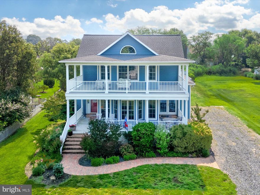 Major Price Reduction – Motivated Seller
The seller is ready to entertain reasonable offers.

Welcome to Oxford, a storybook town where quiet streets, salt-tinged summer air, and friendly waves from neighbors create an unmistakable sense of charm. Nestled along the peaceful Tred Avon River, this beloved waterfront community invites you to slow down and enjoy life’s simple pleasures—sunset strolls by the marina, weekend ferry rides aboard the Oxford-Bellevue, ice cream from Scottish Highland Creamery, or relaxing afternoons at the waterfront park watching sailboats drift by. With local restaurants, tennis and pickleball courts, and boutiques just a short walk away, Oxford offers a lifestyle that is both relaxed and refined.

This four-bedroom, two-and-a-half-bath home sits on a generous in-town lot framed by mature perennial landscaping. Classic double porches welcome you and hint at the thoughtful design inside. Warm handscraped hardwood floors flow through a light-filled living room featuring high ceilings, a fireplace with built-in bookcases, and a sunny bump-out window—perfect for a reading nook or morning coffee.

The open-concept main level balances flow and function. A chef’s kitchen boasts 42-inch cabinets with display shelving, bluestone counters reminiscent of the river, stainless steel appliances, and a six-burner commercial range. Dual breakfast bars offer casual dining, while the adjacent dining area includes a wet bar with beverage fridge and French doors opening to the front porch. At the rear of the home, a vaulted breakfast room with skylights and charming built-in bench seating (with hidden storage) connects to the backyard. A nearby laundry room adds convenience, and a main-level office with French doors provides a quiet workspace.

There are two primary bedroom options. The first, located on the main floor, overlooks the backyard and features a walk-in closet and spa-like en suite with soaking tub, frameless glass shower, and double vanity in warm stone tile. Upstairs, the second primary bedroom offers a cathedral ceiling, river view, two closets, and access to a full bath shared with two additional bedrooms. Extra storage includes a pull-down attic and built-in eave space.

Outdoors, the spacious yard is complete with raised garden beds and a storage shed—ideal for weekend projects or growing herbs and vegetables. There is also potential for an attached garage. A transferable flood insurance policy at just $648 per year provides added peace of mind.

Blending quality finishes, flexible spaces, and timeless coastal appeal, this home embodies comfort, character, and connection. Whether you seek a full-time residence or a weekend retreat, Oxford is ready to welcome you home.