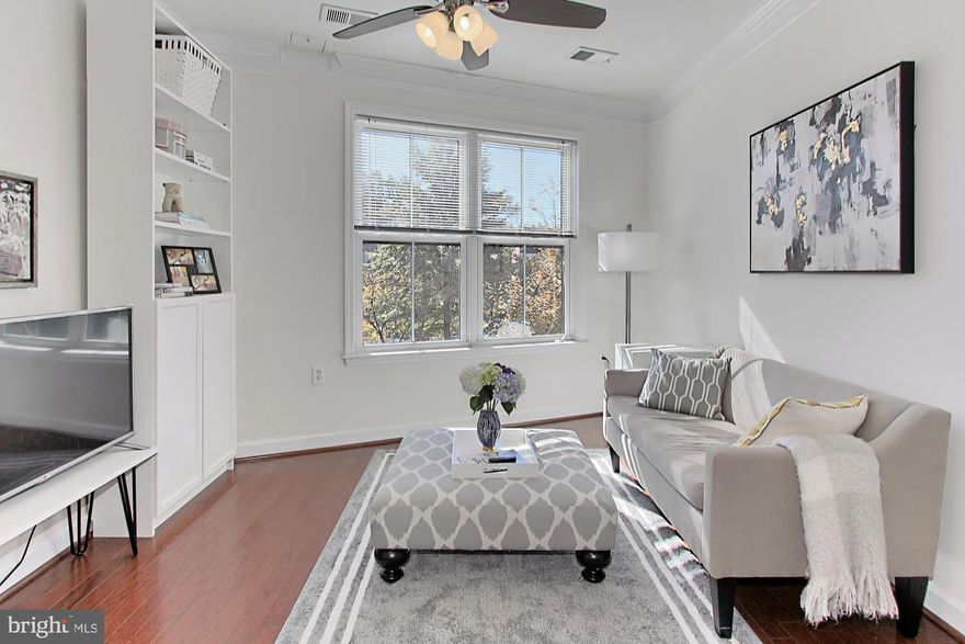 Welcome to Unit #118 at 2101 N. Monroe Street in vibrant Arlington Virginia! Embrace chic urban living in this gorgeous 1 bedroom plus den, 1.5 bath condo located in the highly desirable community of Dominion Heights, a LEED certified, pet friendly, and smoke-free building. With ample living space and garage parking, this South facing home bestows an openness and light not found in many condos and boasts hardwood flooring, contemporary lighting, a versatile den, beautifully updated kitchen and baths, and an abundance of windows with treetop views including a colorful cherry blossom tree. Warm and neutral paint plus loving maintenance ensure that no detail has been overlooked, making it move-in ready and just waiting for you to call your own. While this home has a first floor address it is NOT on the street level, it is 1 level above the street and this is an elevator building for those worried about stairs.   The garage space #G74 is ample in size and easily accessed off of the elevator.  The southern exposure is absolutely exquisite, the natural light in the home is sublime.  The cherry blossom tree directly outside of the living room window is stunning during the Springtime when it is in full bloom. This home is crisp and clean and when the cherry blossom tree is in bloom the most romantic home I have been into in a condominium ever! Rich hardwoods greet you in the open foyer and beckon you into the light and airy living room where twin windows stream natural light illuminating crisp crown molding and a lighted ceiling fan. The adjoining dining area offers plenty of space for all occasions and is accented by a sleek lighting giving it a trendy urban feel. The galley-style kitchen will please the modern chef with gleaming granite countertops, shaker-style 42 inch cabinetry, and quality stainless steel appliances including a gas cooktop and oven. A chic pendant light provides ample lighting, as the breakfast bar adds to the open atmosphere that facilitates entertaining during meal preparation. A powder room with pedestal sink and sleek fixtures complements the main living area of the home. The light-filled master bedroom features rustic-style cork flooring (environmentally friendly, hypo-allergenic, and low-to-no maintenance), a spectacular wall of windows, a walk-in closet tailored with custom shelving, and an en-suite bath updated to perfection with a granite-topped vanity and spa-toned flooring and tub/shower surround. The den offers versatility to fit the demands of your lifestyle including a nursery, home office, or guest/second bedroom; while a laundry closet with full-size stackable machines and one secured garage space perfectly located near the entrance to the elevators complete the comfort and convenience of this wonderful home. All of this is located in an upscale community that is also a commuters dream with easy access to Capital Bikeshare, 3Y Metrobus Stop (direct bus route to McPherson Square), 20 minute walk to Virginia Square Metro, Route 29, I-66, Spout Run, & GW Parkway. Take advantage of diverse shopping, dining, and entertainment choices within a 2-mile radius including Ballston, Rosslyn, Courthouse, and Clarendon. Nearby Custis Trail (traillink.com) is sure to interest the outdoor enthusiast as it connects you to the W&OD Trail and is walkable to this home.  If historical, cultural, or nightlife pursuits are what you seek all that and more can be found just across the Potomac River in Washington, DC.