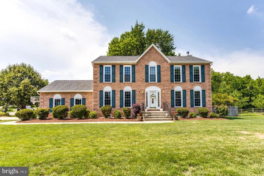 This stunning 4 bedroom, 3.5 bath Spring Haven Woods Colonial home  offers so much both on the interior and exterior! Enter through the stately front door and be welcomed by a two story and immediately be delighted by gleaming, newly refinished hardwoods throughout the main level.  A gourmet kitchen awaits you with stainless steel appliances, granite countertops, a large  island for dining or preparation with pendent lighting, custom  cabinets, a large pantry and recessed lighting.  Area for a kitchen table and easy flow to the family room.  The family room offers a gas fireplace and easy access to the large deck to dine, entertain or admire your fully fenced, and landscaped backyard.  The first floor is rounded out by a half bath dining room and office which have views of the landscaped front yard. The upper level pleases with  a large master suite with a vaulted ceiling, walk in closet and an ensuite bath with a double vanity, soaking tub, shower and linen closet.  Two additional nicely sized bedrooms and a hall bath are located on the upper level.  The lower level is fully finished  with a large recreation room with a gel fuel fireplace, the fourth bedroom, a full bathroom, laundry room and walk-up stairs to the side yard. New HVAC unit and newer architecturally shingled warrantied roof, cat6 cabling, and a seven zone irrigation system.  This beautifully appointed Colonial is conveniently located with easy access to both routes 301 and 210.  Make this your new home!