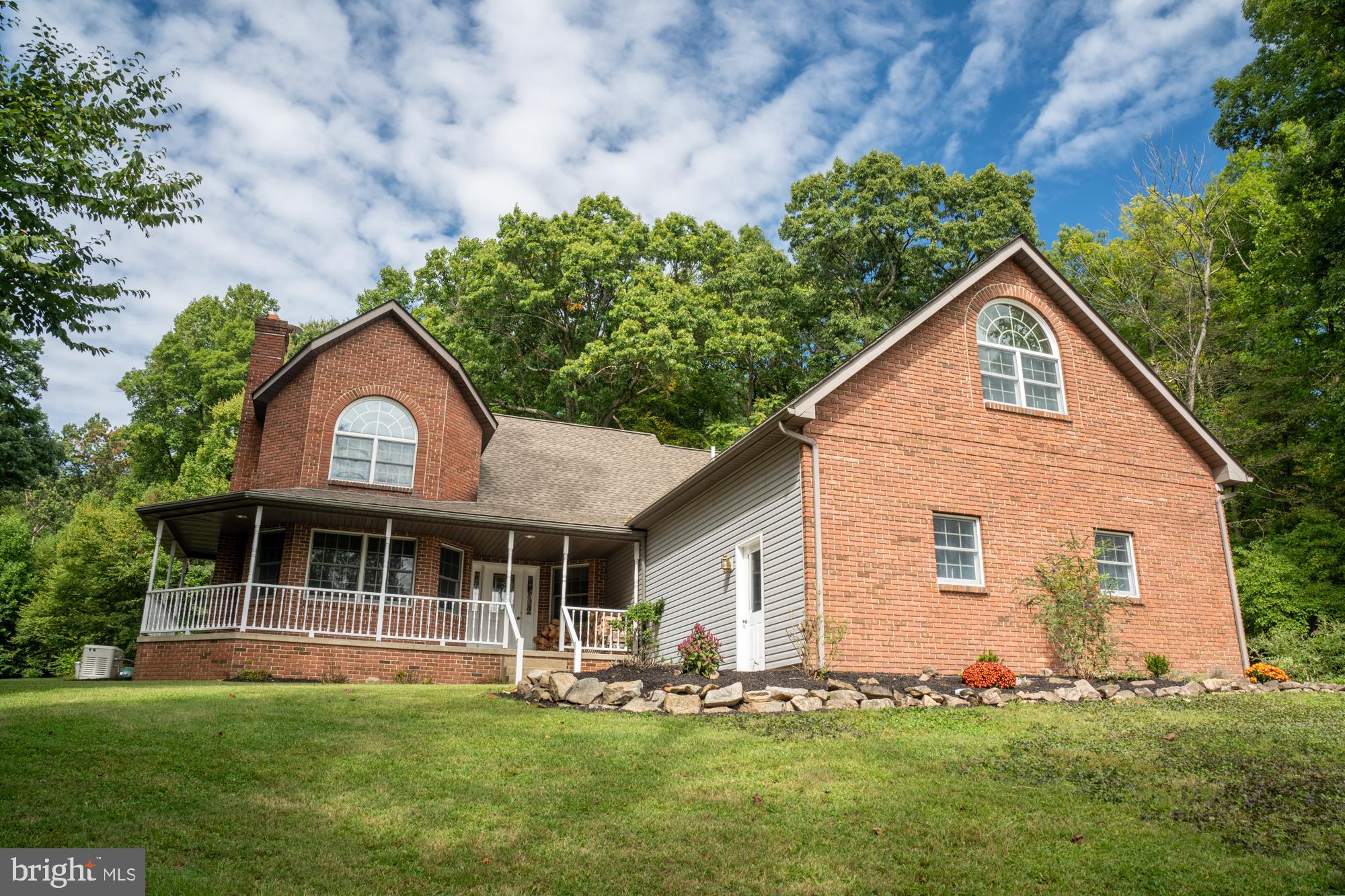 This home was built by a custom home builder for his family, and now it can be yours. This 5-bedroom, 2.5 bath, custom-built home is nestled in the hills of Berks County. This is a rare opportunity to enjoy nature from every angle as you stroll on the wrap-around porch. Recent upgrades include new flooring, new concrete patio area, a new patio door and much more. You will love the cozy den with brick fireplace, 1st floor master bedroom and bath, 1st floor laundry room, hardwood floors, custom oak kitchen, custom trimmed doors and windows, a Generac whole-house generator, huge unfinished basement, cathedral ceilings and an open-air interior home design, all perched on a 3.9-acre lot with yard and woods, plus so much more. This has been one family’s happy place for decades, and now it can be yours if you act quickly. The home, the craftsmanship, the setting, and the magnificent views are a commodity in today’s real estate marketplace. Best of all, this home is located just minutes from Rt. 100 and centrally situated between Reading, Allentown, and Philadelphia.