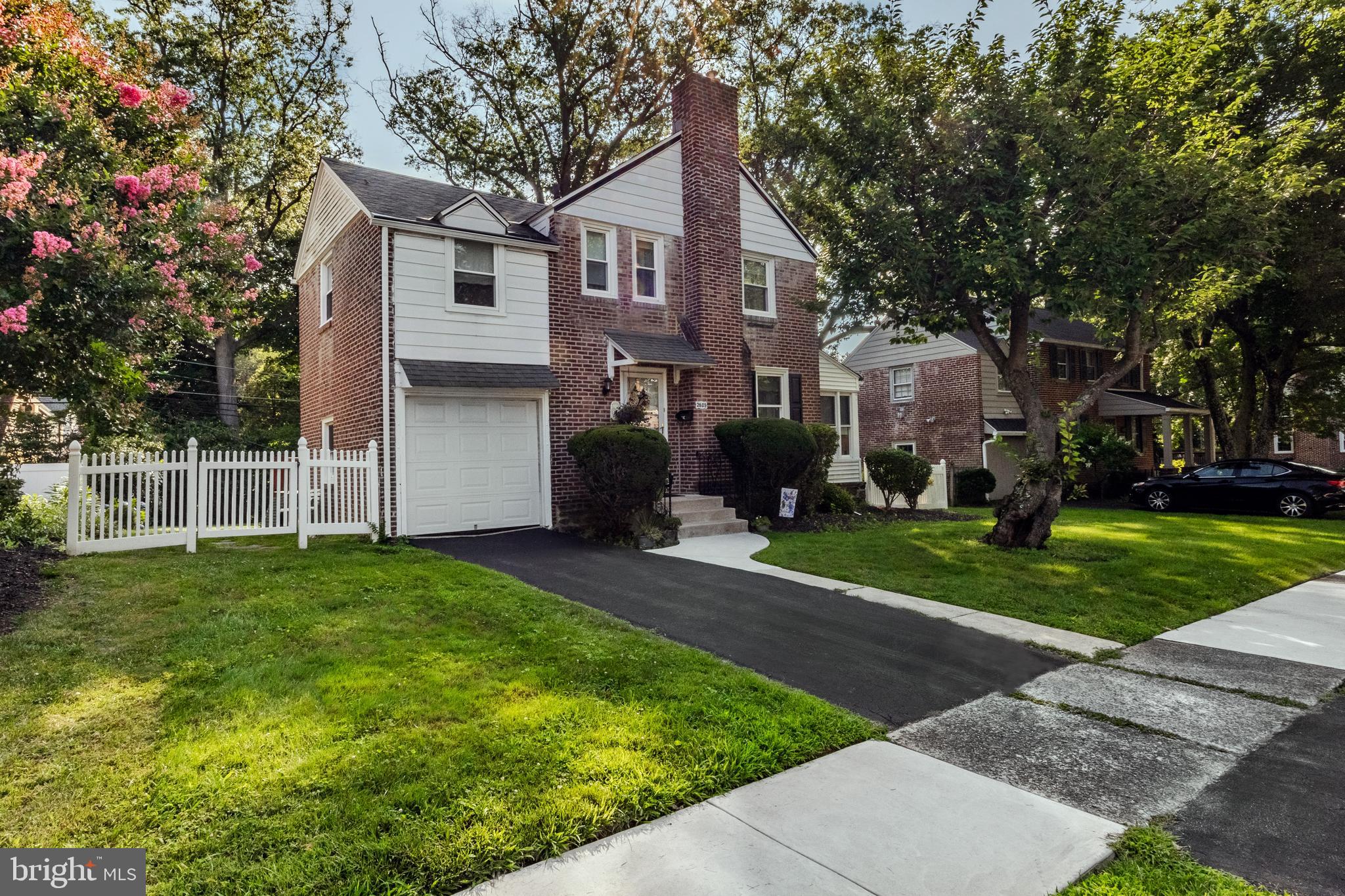 If you’ve been looking for just the right opportunity in one of Haverford Township's most coveted locations, this is it. 2605 Woodleigh has been loved and cherished by its current owners for 59 years. When you walk in the front door of this classic brick front Colonial, you can feel the love that's lived here all these years. This home features 3 bedrooms on the 2nd floor, including a primary bathroom, a hall bathroom, and ample closet space. The first floor has a large living room with a gas fireplace and traditional mantle, perfect for dressing up at the holidays. Off the living room is a great den, perfect for watching TV or having your morning cup of coffee. The dining room is spacious and can accommodate a nicely sized table, buffet, and cabinet. The eat-in kitchen has white shaker cabinets, oak hardwood floors, tiled backsplash, and a door that leads you out to the large back deck and level backyard. The basement of the home is currently unfinished, but could be! For now, it offers great storage space and a nice laundry area. This home is the perfect opportunity to make something your own, but move in and enjoy while doing it. The property itself offers everything you’ll want and need over time- a private driveway, a great backyard, a back deck, and an attached garage. This home has been loved throughout all its years and offers a rare opportunity in the coveted Paddock Park section of Havertown. Paddock is known for its walkability to Paddock Park, the YMCA, and all things Oakmont. Don’t let this opportunity get away. It’s a true gem.